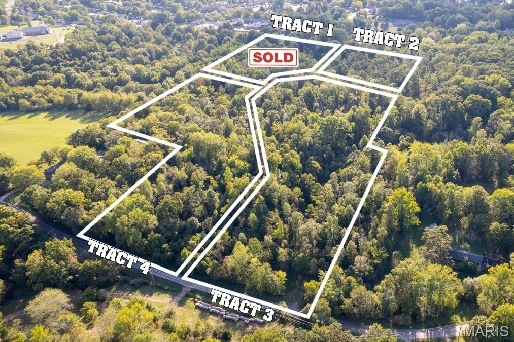 NO DEED RESTRICTIONS
Located just outside the Cape Girardeau city limits between West Cape Rock Road and Old Sprigg St Road, this rural-feel timbered land tract is comprised of four smaller tracts, but yet in an urban setting.  This is one of those unrestricted development opportunities that rarely come available with private acreage so close to city limits.  
Currently available for sale are Tracts# 2, 3, & 4.  These tracts can be purchased individually, in any combination, or as a whole.  With paved road access, electric utility accessibility at the roadside, and entrance locations to each tract, these exclusive lots with private recreational acreage are in a natural state and ready for excavation and construction for whatever a Buyer envisions.  With varying topography throughout, there are also potential areas for pond excavation and development for each tract.
The wildlife is spectacular throughout this raw land.  This property was once labeled as a deer sanctuary and home to an abundance of whitetail deer and much other wildlife that frequent the area.  
Located on the edge of city limits, these timbered tracts provide the privacy and seclusion of a rural property, but yet places you just minutes from the Downtown Cape Girardeau Riverfront business district, and shopping amenities that the city offers.  Imagine the feeling of rural living with the benefits of urban accessibility.
Rarely available, this type of unrestricted land so close to town won’t last on the market.