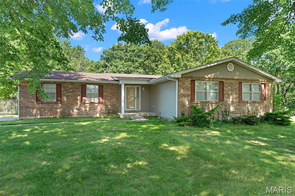 WOW, here's your opportunity to put a little sweat equity into this SOLID, well laid out 3 bed, 2 bath spacious home with walkout lower level, nestled on 3.03 acres in Franklin County.  With mature trees in the front yard, the curb appeal invites you home.  Main floor features open concept living with spacious living room that flows well into the large eat in kitchen.  A unique step down sunken hearth room off the kitchen features wood burning fireplace and leads out through sliding glass door to the deck and large back yard.  A center hallway plan gives way to two large bedrooms, a full bathroom and spacious primary bedroom with private en-suite for privacy and convenience. Beautiful luxury vinyl plank flooring has already been laid in the three bedrooms and hallway.  Prep work has already been started for you in the entry-way, living room and hearth room to start laying the remaining already purchased total main floor square footage of the vinyl plank flooring.  With a little bit of paint and flooring this main living space will be a home sweet home to be proud of.  Need more space- there's options!  Your lower level walk out basement has a ton of space to add additional living space with ease.  Or retreat to the awesome carriage house detached garage that has been upgraded to a studio complete with drywall, electric, mini-split unit and flooring completed with chip & seal. The possibilities are endless for this cute flex space.  You will love owning your own piece of the pie just outside of town, with 3.03 acres giving a blend of nice useable "yard" space, along with a fantastic private lay of the land with heavy wooded area, with abundant wildlife. Catch glimpses of deer and turkey with your morning coffee!  Attached garage features a air compressor that stays, shelving and room for outdoor toys!   HVAC 2020, Water Softener, Well pressure tank 4 years new.  Come check out this home. With just a little bit of work, she will shine like the diamond she is!  SELLING AS-IS.