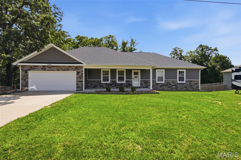 This beautiful 4-bedroom, 3-full-bath home offers the rare opportunity to own a 3 year old home on 7.83 acres of unrestricted land- AND STILL be close to town and Fort Leonard. Since it is such a newer home buyers can spend less time worrying about the high ticket items such as the roof, HVAC system, appliances, and other major features, and more time to enjoy the home and property and less reason to expect costly replacements right away.

The thoughtfully designed main level features an open kitchen, dining and living area filled with natural light. From the dining area, step directly onto the covered back deck overlooking your own wooded acreage—with no neighbors directly behind you, just land, trees, and plenty of deer wandering throughout.

The large primary bedroom offers plenty of space and includes a private bathroom with a double vanity, and a large walk-in closet. Two additional bedrooms and another full bathroom complete the main level.

The walk-out basement adds a large recreation area, fourth bedroom, full bathroom, laundry area and bonus room. It also includes a separate John Deere garage, perfect for the mower, ATV, tools, or use as extra storage!

The sellers have created their own little camping spots throughout the property and enjoy exploring the woods. 

 Enjoy the convenience of  living  close to town, while still having nearly 8 unrestricted acres, no neighbors directly behind you and a beautiful newer home—all at a reasonable price. Buyers searching in the St. Robert–Waynesville area know this combination does not come along often. Come take a look and share your thoughts!