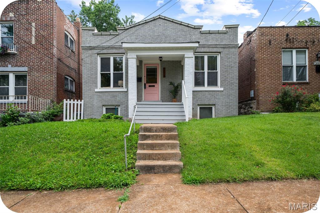 Step inside this sweet little brick bungalow in the popular Dogtown neighborhood and be prepared to fall in love!  This centrally located well-maintained home on a quiet street is the perfect home for a first-time homebuyer close to parks, dining and fun! Walk in the front door and find a charming light filled living room with exposed brick and decorative fireplace.  Two good-sized bedrooms also have exposed brick walls with newer paint, ceiling fans and light fixtures. The recently updated bathroom is thoughtfully modern with ceramic wall tile, a claw foot tub and updated fixtures. The kitchen is as sweet as they come with a good amount of storage, floating shelves, modern backsplash and all appliances can stay. 
The walkout basement has tons of storage and could be finished off to add additional living space. Head out to the backyard and find a good-sized level yard with a two-car parking pad for off street parking. Now for the updates! Roof is less than 1 year old, HVAC 4 years old, new sewer lateral under the house and PVC stack.  With all of these wonderful updates you can live worry free and focus on living that Dogtown lifestyle!!!