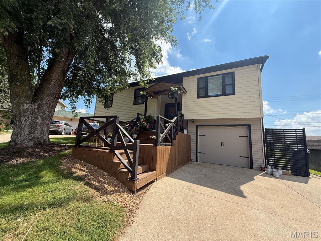 Welcome to this three bedroom and two bathroom home. This split-level home offers living space on both the main level and the lower level. The main level has living room that adjoins the dining room and kitchen. Dining room has built in cabinets. The kitchen has wood cabinets and appliances convey. There is a deck off the dining room with access to the fenced backyard. Three bedrooms and one full bathroom on the main level. The lower level has a family room, storage room, laundry room with bathroom, and one car attached garage. Driveway is large enough to park two cars. Located on a cul-de-sac.