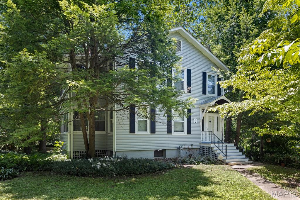 Welcome home to this distinguished 4-bedroom, 1.5-bath residence, set on a private, tree-lined lot of nearly half an acre. Offering over 1,500 square feet of comfortable living space, this home is full of character — from the handsome wood floors flowing through much of the home to the classic pocket doors that reflect an era of craftsmanship rarely found today. The kitchen has been refreshed with new flooring, and fresh paint throughout most of the house lends a polished, move-in-ready feel. Two wood-burning fireplaces anchor the home's inviting living spaces, while multiple fully enclosed sunrooms offer light-filled retreats for a home office, reading nook, or quiet afternoons surrounded by mature trees. A detached garage adds convenience and extra storage. This is a rare opportunity to own a home with true character in a private setting, schedule your showing today!
