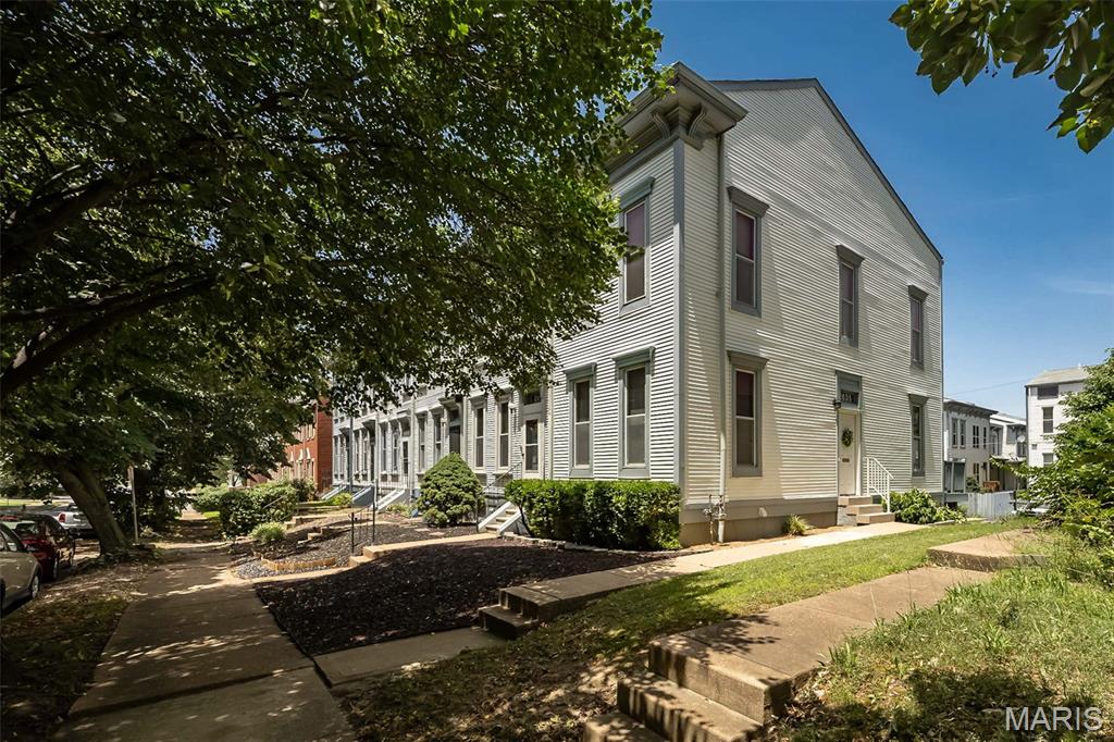 Exceptional opportunity to own a beautifully maintained townhome in one of St. Louis' most desirable and convenient locations! From the moment you step inside, you'll be welcomed by a light-filled, open floor plan featuring gleaming hardwood floors, soaring ceilings, and a cozy fireplace that anchors the inviting living space. The seamless flow leads directly into the kitchen, which offers oak cabinetry, granite countertops and brand-new kitchen flooring (2025) that adds a fresh, modern touch. Step through the open dining area onto your private deck—rebuilt in 2024—offering a peaceful outdoor retreat for morning coffee or hosting family and friends. Upstairs, you’ll find two bright, comfortable bedrooms sharing a well-appointed hall bathroom. This shared bath serves as a relaxing, spa-like escape, featuring a luxurious jetted tub positioned right beneath a bright skylight. Practical updates throughout the home ensure total peace of mind, including all-new entryway doors (2021) for enhanced curb appeal and energy efficiency, plus an attached garage providing security, convenience, and extra storage. Perfectly situated directly across the street from Eads Park and just a short stroll to Lafayette Park, this home offers unparalleled access to some of the city's most treasured green spaces. Enjoy the ultimate urban-suburban balance, remaining just minutes from downtown, major employers, premier dining, shopping, and major highway access. Meticulously maintained and entirely move-in ready, this townhome beautifully combines modern updates with timeless appeal. Schedule your private showing today!