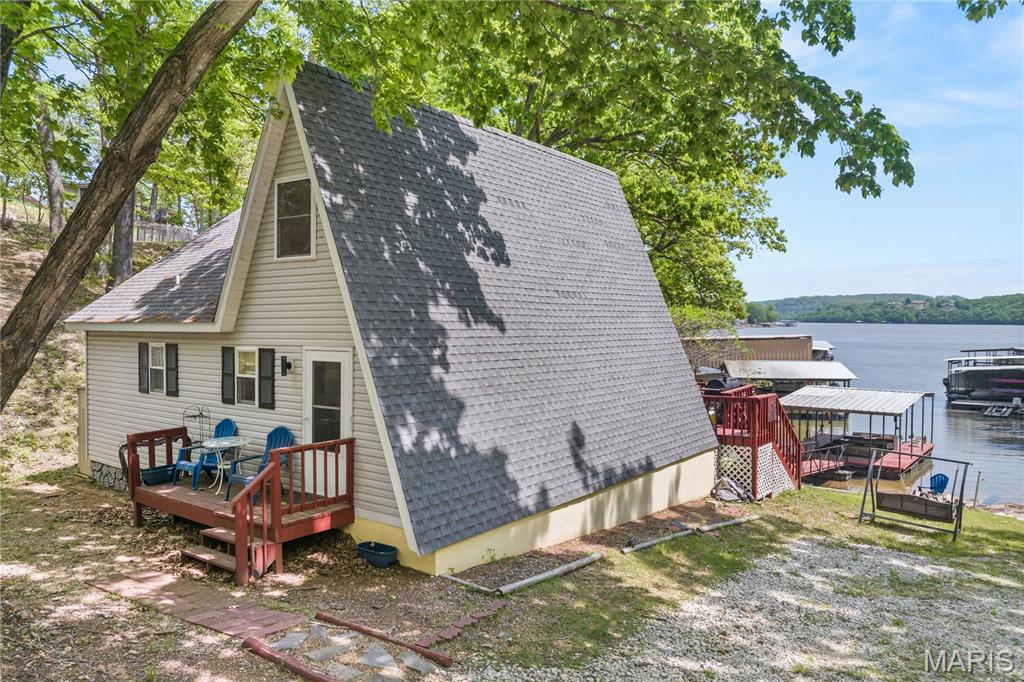 Escape to your private sanctuary in Sunrise Beach. Situated over half an acre at MM39, this cozy 2-bedroom, 1-bathroom A-frame is a lakefront treasure previously featured on HGTV’s Lakefront Empire. Perfectly positioned for both relaxation and profit, this home allows nightly rentals and comfortably sleeps eight, surrounded by mature trees and absolute tranquility. Inside, discover a bright, open-concept interior featuring tasteful furnishings, freshly painted walls, new flooring, and updated lighting throughout. Modern essentials include a smart thermostat, newer windows/doors, and custom cabinetry. The living space flows effortlessly to a spacious, restored deck—the ultimate vantage point for breathtaking lake views and outdoor gatherings. Enjoy 80 feet of private lakefront with an easy walk to your private one-well dock, newly equipped with updated electrical and integrated speakers. Located conveniently by land and water to premier dining and shopping, this property is truly move-in ready. Whether you are looking for a high-performing investment or a personal slice of paradise, this is the one. Experience the magic today via the fully interactive virtual tour!