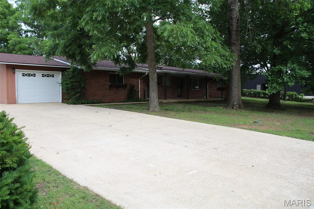 Welcome to 13 Green Meadows Drive in Doniphan, Missouri! This beautiful brick home offers the perfect combination of comfortable living and valuable extra acreage. Featuring 4 bedrooms and 2 full bathrooms, the home provides plenty of space for a growing family, entertaining guests, and everyday comfort.

Enjoy the additional living and entertainment space provided by the finished basement, or step outside to the relaxing back patio, perfect for cookouts, morning coffee, or unwinding after a long day.

A convenient storage and workshop area with direct access to the enclosed garage offers plenty of room for hobbies and projects.

In addition to the home, the property includes two additional half-acre lots that are cleared, level, and already have utilities available. Whether you're looking for extra yard space, future building opportunities, or investment potential, these lots offer tremendous value and flexibility.