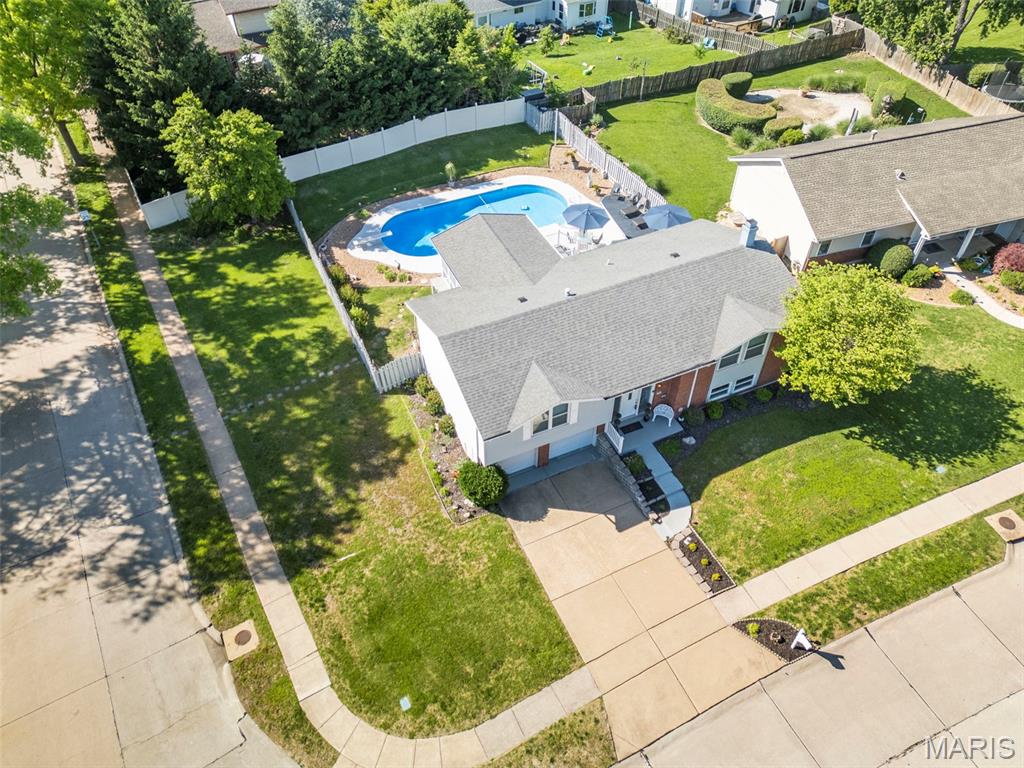 Some homes on a street are just maintained. This one has been loved! The owners purchased 12741 Parkway Estates Drive when it was just one year old, and the past 50 years of care are visible the moment you arrive. The corner lot tells you something before you even get to the front door! 

Start at the sunroom addition. It is enormous, flooded with natural light on three sides, and positioned directly off the eat-in kitchen so the connection between inside and outside is immediate. Through the glass, the inground pool and the fully fenced, professionally landscaped yard come into full view. The pool terrace, the newer paver patio, the mature plantings, the privacy. Step into that sunroom and you understand immediately what makes this property different from everything else on the street. It is the kind of room that changes how the whole house lives, and it makes every season feel like the right one to be home.

The main level is built around that kitchen-to-sunroom flow. The white eat-in kitchen connects to both the formal dining room and the sunroom, keeping the layout practical for weeknight dinners and weekend gatherings. Whether you are cooking for two or hosting a full house, the view from the kitchen through to the pool keeps you connected to the outdoor space at all times. Three bedrooms and two full baths complete the upper floor, along with the family room. You'll love the primary bed/and luxury bathroom updates! The corner lot brings more natural light and more yard than interior lots on the street, a detail that sounds minor until you are standing in it.

The lower level is a fully functional, separate living zone built around a walkout to the yard and pool. A fourth bedroom, a family room centered on a wood-burning fireplace, a wet bar, a 3/4 bath, and a dedicated laundry area give this level everything it needs to function independently from the main floor. The two-car attached garage also enters at this level. Whether you need a guest suite, a work-from-home setup, an extended family configuration, or all three, the layout handles it without compromise. The walkout means the lower level never feels like a basement; it feels like additional living space that happens to have direct access to a pool.

Outside, the inground pool sits at the center of a yard that reflects 50 years of consistent care. The fencing is solid. The landscaping is established and mature in a way that takes decades to achieve. The newer paver patio and pool surround are in the kind of shape that comes from people who actually use the space and take care of it, not from a pre-sale refresh.

Parkway C-2 schools. McKelvey Elementary, Northeast Middle, Parkway North High School.

New HVAC (Furnace and A/C). New electrical panel. Newer roof.  Newer pool liner and updated and maintained pool systems. 

The location is one of the most practical in the 63146 zip code. Highway 364 and I-270 are both just minutes away. Westport Plaza, newly revitalized with restaurants, entertainment, and retail, is essentially around the corner. Lambert Airport, St. Louis County Library, and public transportation are all within easy reach. The neighborhood is quiet and well-kept, the kind of block where the pride of ownership is visible at every property on the street.

A pool home on a corner lot with a sunroom addition, four bedrooms across two levels, three full baths, a new electrical panel, and 50 years of caring ownership in Parkway North schools. This combination does not come to market often in the 63146 zip code. When it does, it doesn't stay long... this one sure won't!!