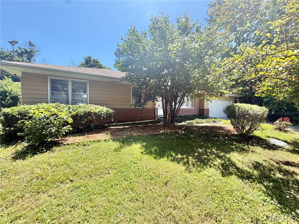 Opportunity knocks with this 3-bedroom, 2-bath ranch home offering solid bones, generous living space, and endless potential. Hardwood floors are believed to be underneath the carpet, waiting to be uncovered and restored to their original beauty. The main level features a spacious living room highlighted by a classic brick fireplace, a separate dining room, an eat-in kitchen, and the convenience of main-floor laundry. The primary bedroom includes a private full bath, while two additional bedrooms and a second full bath complete the main level. The walk-out lower level provides a wealth of additional living space, including a large recreation/family room, bonus room, sleeping area, and ample storage. An existing shower in the unfinished portion presents an excellent opportunity to create a third full bath and add even more value. Situated on a combined .52-acre lot that includes an additional parcel, this property offers plenty of outdoor space while remaining conveniently located near parks, shopping, and highway access. A 1-car garage adds to the home’s functionality. Bring your vision and make this home your own. Property is being sold as-is. Seller to make no repairs or provide inspections.