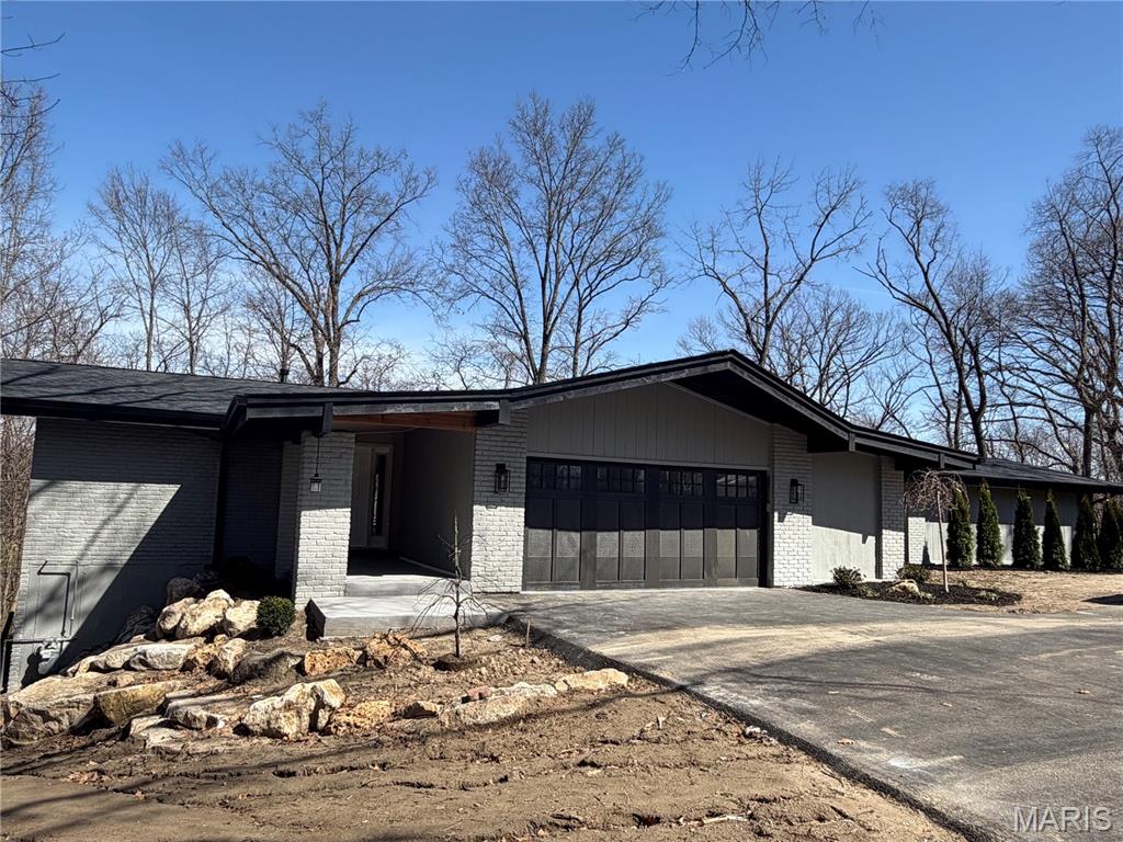 Exceptional hilltop retreat in the highly sought-after Green Trails neighborhood. This completely gut-rehabbed contemporary walk-out ranch offers 5 bedrooms and 3.5 baths on a spectacular 1.2-acre lot surrounded by wooded common ground, providing rare privacy while being ideally located in the heart of the community just minutes from top-rated schools, dining, and shopping.
Thoughtfully redesigned with high-end finishes throughout, the home features pre-finished white oak flooring, custom cabinetry, quartz countertops, and designer lighting. The stunning kitchen is equipped with GE Cafe Appliances along with wine and beverage refrigerators, creating an ideal space for both everyday living and entertaining.
The luxurious primary suite serves as a private retreat with a vaulted shiplap ceiling, two walk-in closets, and direct access to a private patio. The spa-inspired primary bath features a double vanity and an oversized walk-in shower with seating.
The walk-out lower level offers a dramatic sunken family room with a stone-faced fireplace and wet bar—perfect for gatherings, relaxing evenings, or hosting guests.
Extensive upgrades include Pella windows and doors, a new architectural shingle roof, composite deck, new asphalt driveway, professional landscaping, zoned HVAC, a 75-gallon water heater, and a Generac generator. Walk-in closets in four of the five bedrooms provide excellent storage and functionality.
A rare opportunity to enjoy modern luxury, exceptional privacy, and a prime location in the heart of the sought-after Green Trails community.