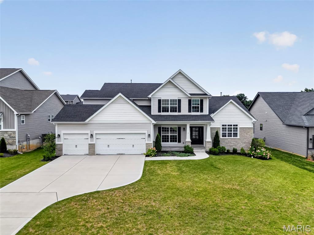Why build and wait when you can move right into this impeccably maintained, fully upgraded Designer Series Muirfield model? Located at 3 Warchol Court in the prestigious Inverness community, this better-than-new, 4 bedroom, 3.5 bathroom, 1.5 story luxury residence with nearly 3,800 sq. ft. offers the rare opportunity to enjoy all the benefits of new construction without the delays, uncertainty, or added expense. Positioned on a quiet cul-de-sac in an established phase of the neighborhood, this pristine three-year-old home includes thousands of dollars in enhancements already completed for you, including professional landscaping, an expansive poured concrete patio, and a multi-zone smart irrigation system—eliminating many of the costly upgrades often encountered after closing on new construction. Thoughtfully designed with both elegance and functionality in mind, the home showcases exceptional craftsmanship and upscale finishes throughout. The stunning great room features soaring 11-foot ceilings, sun-filled transom windows, and stone fireplace, creating a warm yet sophisticated gathering space. At the heart of the home, the gourmet kitchen is beautifully appointed with a professional gas cooktop, stainless vent hood, built-in wall oven, farmhouse sink, under-cabinet lighting, and generous entertaining space that flows seamlessly into the main living areas.
A striking wrought-iron staircase leads to an elevated bonus retreat, offering flexible space ideal for a private office, media room, playroom, or lounge. The luxurious main-level owner's suite serves as a peaceful sanctuary, highlighted by spa-inspired Calacatta-style tile, a deep soaking tub, an oversized walk-in shower with frameless glass enclosure and matte black fixtures, dual vanities, and a spacious walk-in closet. Additional features include programmable climate control, an Aprilaire whole-home humidifier, and an oversized three-car garage. Residents enjoy access to Inverness' exceptional 106-acre master-planned setting featuring scenic lakes, walking trails, pickleball courts, and highly acclaimed Wentzville schools. For golf enthusiasts, Lake Forest Country Club is just a short golf cart ride away, offering private golf and social memberships, along with seasonal pool and pickleball access. Skip the construction delays, builder markups, and disruption of ongoing development. This luxury home offers the convenience of immediate enjoyment, the value of completed upgrades, and the lifestyle you've been waiting for.