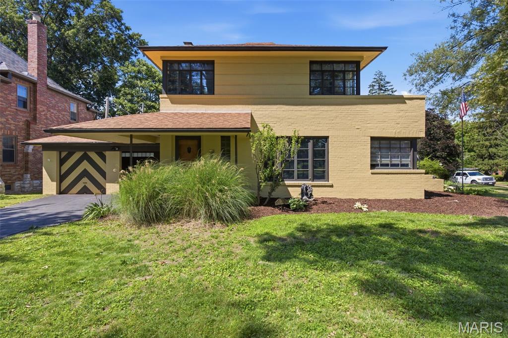 Nestled on a picturesque, tree-lined street in the historic Pasadena Hills community, this beautifully updated brick home blends timeless architectural character with today's modern conveniences. Inside, you'll find a thoughtfully renovated interior that preserves the home's original charm while incorporating stylish updates throughout. Step into the oversized living room, where original wood floors add warmth and character, complemented by fresh paint that creates a bright, move-in-ready feel. The fully updated kitchen features granite countertops, stainless steel appliances, and ample workspace for everyday living and entertaining. Just beyond, the separate dining room opens directly to a private patio, creating an ideal setting for indoor-outdoor gatherings. Both bathrooms have been tastefully refreshed, offering a clean, modern aesthetic while remaining true to the home's classic design. Upstairs, each bedroom enjoys access to a shared second-floor balcony—perfect for sipping your morning coffee or unwinding with an evening nightcap. The partially finished basement provides additional living space and offers excellent potential for a family room, recreation area, home office, or workout space. An attached garage, central air conditioning, and forced-air heating provide everyday comfort and convenience, while the spacious lot offers plenty of room to relax, garden, or entertain outdoors. Mature landscaping and established trees further enhance the property's curb appeal and neighborhood charm. Located within one of North St. Louis County's most architecturally distinctive communities, this home offers the perfect combination of historic character, modern updates, and neighborhood pride. Convenient access to parks, shopping, major highways, and downtown St. Louis makes this a wonderful opportunity to enjoy the best of both charm and accessibility.