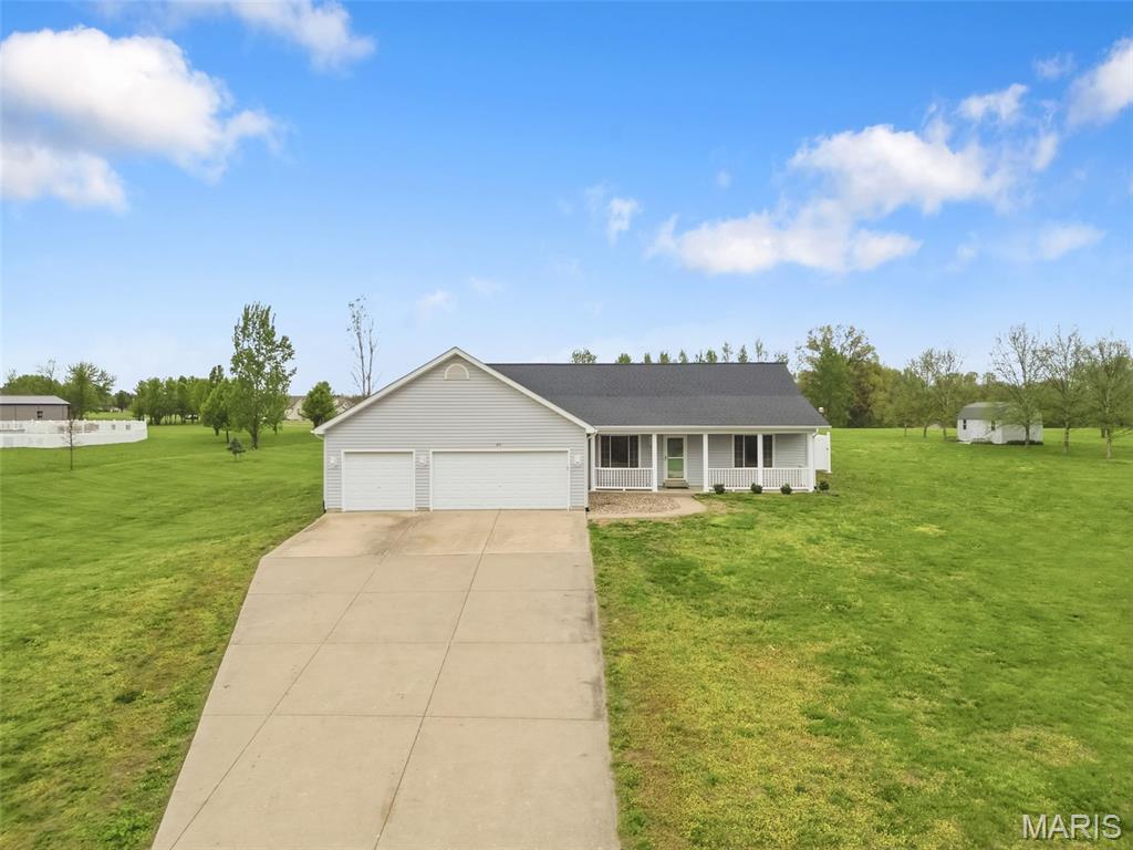 BACK ON MARKET!!!! Enjoy the best of both worlds with this 3-bedroom, 3 full bath ranch featuring a split bedroom floor plan on 3 acres in a quiet subdivision in unincorporated Foley, located in the Winfield school district. You get that peaceful country feel while still being just a short drive from town. Inside, the home offers a comfortable and functional layout with main floor laundry, 6-panel doors and tinted windows that help with privacy and energy efficiency. The kitchen is equipped with a reverse osmosis water filtration system, and the home is already wired for surround sound, making it easy to settle in and enjoy. The finished basement has been freshly painted, new LVP flooring and provides flexible space for a rec area, 2 additional sleeping rooms/home office/exercise/craft room. Step outside and you will find a backyard set up for relaxing and entertaining. The above ground pool, hot tub, pergola, fire table, and patio furniture can all stay, giving you a ready-made outdoor retreat. There is also a shed for your outdoor equipment, gutters set up for rain barrel collection, and plenty of open space to spread out and enjoy the property.
The 3-car garage offers plenty of room for vehicles, storage, or hobbies. Updates include HVAC in 2023 and a roof in 2019, soffits, fascia, gutters 2025, new carpet in bedrooms 2 & 3, all adding peace of mind for the next owner. If you are looking for space, comfort, and a move-in ready setup with great outdoor features, this one is worth a look. Country living with convenience close by.