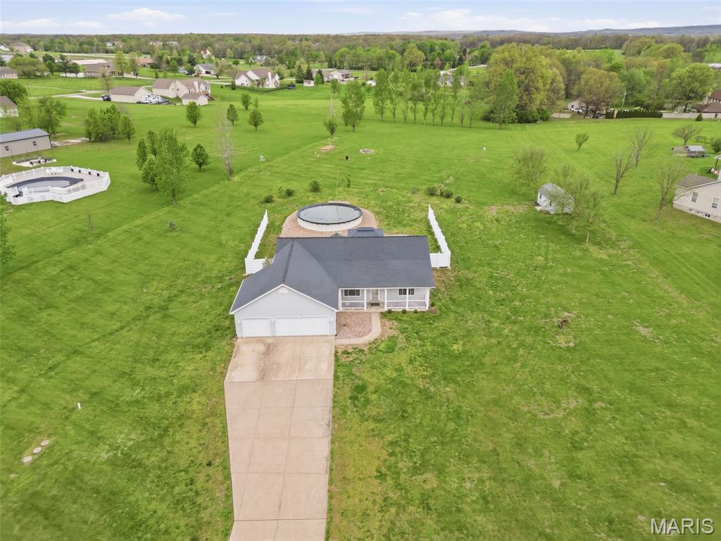 BACK ON MARKET!!!! Enjoy the best of both worlds with this 3-bedroom, 3 full bath ranch featuring a split bedroom floor plan on 3 acres in a quiet subdivision in unincorporated Foley, located in the Winfield school district. You get that peaceful country feel while still being just a short drive from town. Inside, the home offers a comfortable and functional layout with main floor laundry, 6-panel doors and tinted windows that help with privacy and energy efficiency. The kitchen is equipped with a reverse osmosis water filtration system, and the home is already wired for surround sound, making it easy to settle in and enjoy. The finished basement has been freshly painted, new LVP flooring and provides flexible space for a rec area, 2 additional sleeping rooms/home office/exercise/craft room. Step outside and you will find a backyard set up for relaxing and entertaining. The above ground pool, hot tub, pergola, fire table, and patio furniture can all stay, giving you a ready-made outdoor retreat. There is also a shed for your outdoor equipment, gutters set up for rain barrel collection, and plenty of open space to spread out and enjoy the property.
The 3-car garage offers plenty of room for vehicles, storage, or hobbies. Updates include HVAC in 2023 and a roof in 2019, soffits, fascia, gutters 2025, new carpet in bedrooms 2 & 3, all adding peace of mind for the next owner. If you are looking for space, comfort, and a move-in ready setup with great outdoor features, this one is worth a look. Country living with convenience close by.