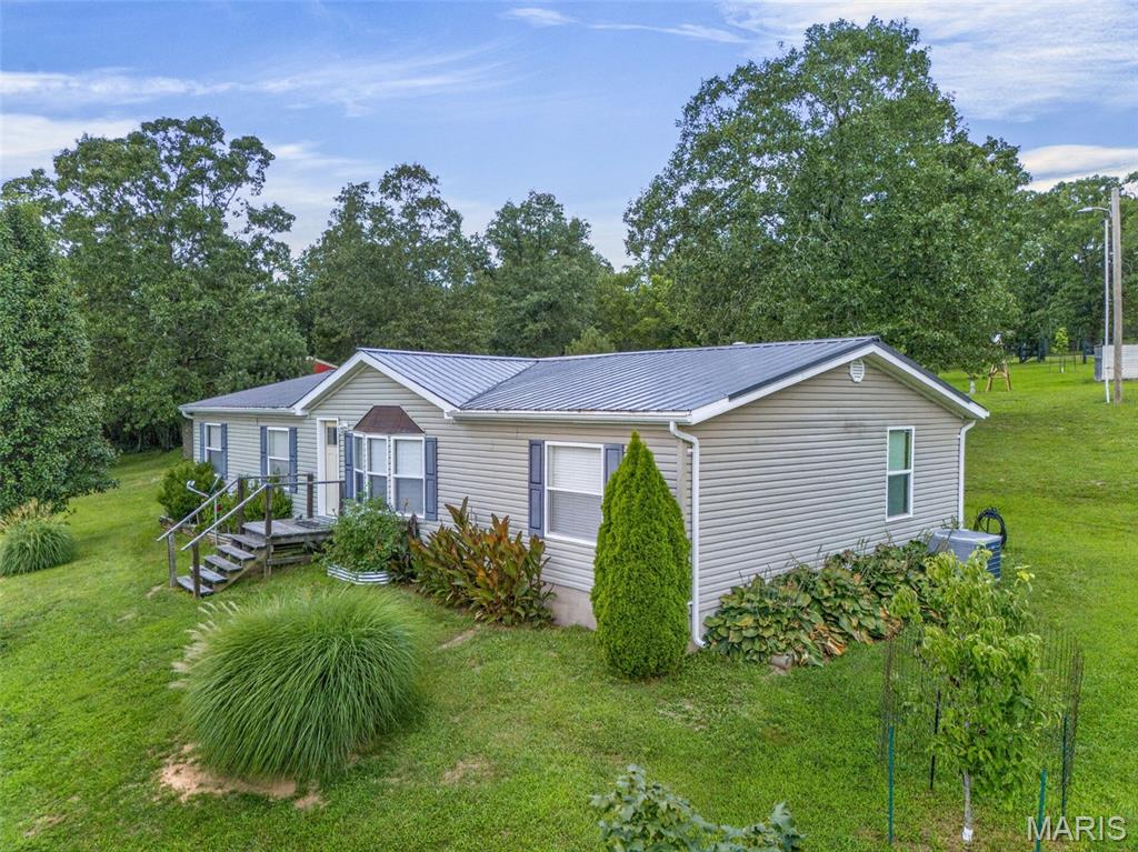 Welcome to your own private oasis! Nestled on approximately 4.8± acres of gently rolling countryside, this beautifully maintained modular home offers the perfect blend of peaceful country living and everyday convenience. Wake up each morning to breathtaking views of rolling hills and picturesque pastureland right from your front door.
The home features a spacious, well-designed floor plan with warm wood cabinetry in the kitchen, a stunning new front entry door, and a large primary suite complete with a private bath and generous space to unwind. Outside, you'll love the concrete driveway leading to a detached two-car garage, along with additional storage sheds that provide plenty of room for tools, equipment, or hobbies.
Whether you're enjoying your morning coffee on one of the peaceful sitting areas or watching the sunset over the surrounding countryside, this property is designed to help you slow down and enjoy the beauty around you. Located just minutes from town, you'll appreciate the convenience of nearby amenities while still enjoying the privacy and tranquility of country living. If you've been searching for a move-in ready home with incredible views, usable acreage, and a setting that truly feels like a retreat, this is the one you've been waiting for!