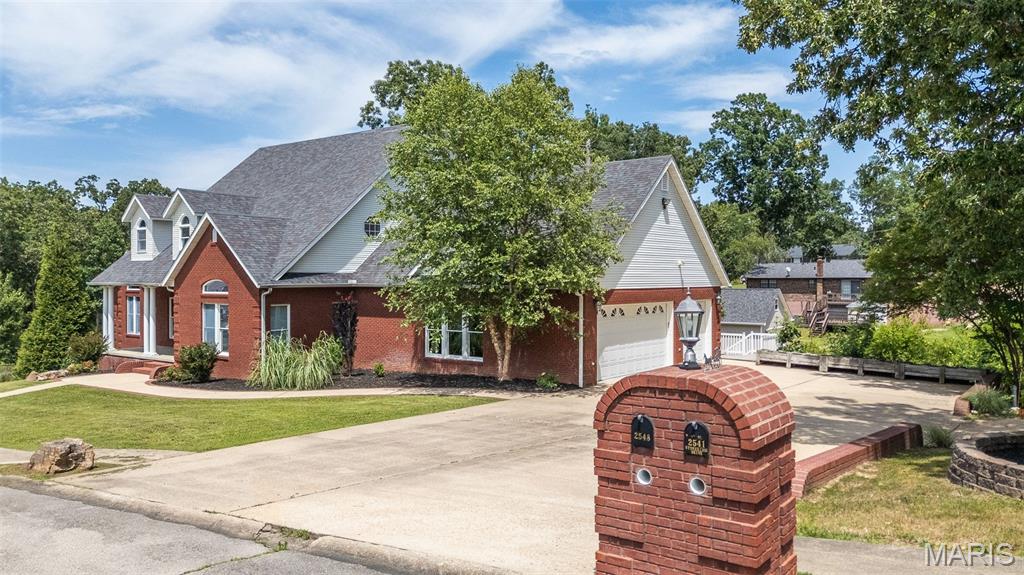 Exceptional custom-built brick home offering 5 bedrooms and 5 baths on a spacious double lot. Designed with both everyday living and entertaining in mind, this impressive home features an open floor plan, formal dining room, and a beautiful fireplace creating a warm and inviting atmosphere. The well-appointed kitchen boasts a gas cooktop, abundant cabinetry, and extensive counter space, while a second kitchen provides added convenience for guests or multi-generational living. The walkout basement includes an additional utility garage, complementing the attached 3-car garage for ample storage and workspace. The oversized primary suite offers a luxurious retreat with a jacuzzi tub, tile shower, and double vanities. Outside, enjoy the privacy-fenced backyard and all the space and quality this remarkable property has to offer.