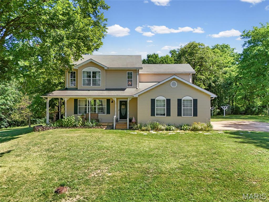 This beautiful, well-maintained home sits in a quiet and peaceful neighborhood with only 6 homes total. You are greeted by 2 fairly flat acres with a mix of yard and trees that back up to more wooded land that provides lots of privacy. As you walk into the cozy living room you'll find a wood-burning fireplace with a natural wood mantel and large windows. The dining room boasts more natural light from the bay window overlooking the beautiful backyard. The large kitchen is open and airy with lots of cabinet space and beautiful butcher block counters. The main floor also includes a laundry room and a half bathroom. Upstairs, you'll find 3 large bedrooms with lots of storage, a full hall bath and a large ensuite primary bathroom with a soaking tub and separate shower. This home has a full. unfinished basement with a walkout and plumbing stub-ins for a potential bathroom.