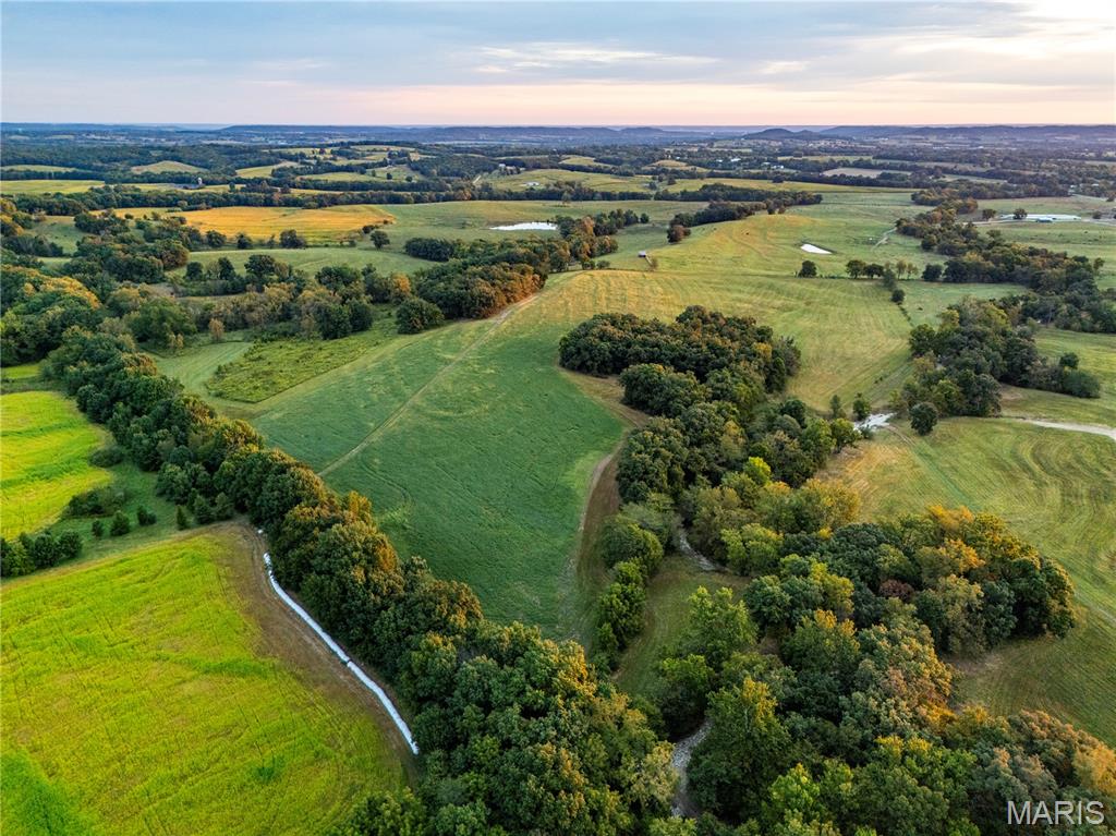 124.5+/- acres featuring underground electric and county water, mature timber, and breathtaking views. This property is rich with wildlife, including turkey and monster bucks. Deed restrictions allow for up to three homes (each a minimum of 1,200 sq. ft.) and prohibited uses include hog confinement facilities, mobile or modular homes, junkyards, ATV or race tracks, and commercial logging, except as necessary for establishing homesites. Additional acreage available. A rare opportunity to own a truly remarkable piece of land with endless potential! Agent Owned.