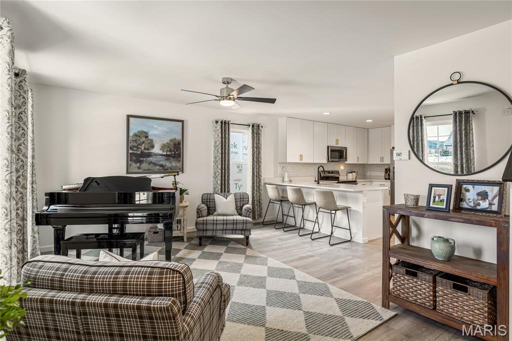 Beautiful move-in ready 2-bedroom, 2.5-bath townhome built by award-winning McBride Homes and completed in December 2025. The popular Georgetown floor plan offers an open, light-filled layout with wide-plank vinyl flooring, neutral finishes, and large windows throughout. A welcoming porch leads into a spacious living room that flows seamlessly into the dining area and chef-style kitchen. The kitchen features 42" white shaker cabinets, quartz countertops, a custom mosaic tile backsplash, stainless steel appliances, and abundant storage. Upstairs, the primary suite offers walk-in closets and a private ensuite bath, creating a relaxing retreat. The second floor also includes a generous second bedroom, bonus room, full hall bath, and convenient laundry area. Enjoy low-maintenance living with lawn care and snow removal included. Community amenities include pickleball courts, playgrounds, splash pads, and scenic walking trails. Ideally located minutes from shopping, dining, and with easy access to Highways 364 and 64. 

Seller is offering a $3,000 credit toward the buyer's closing costs.