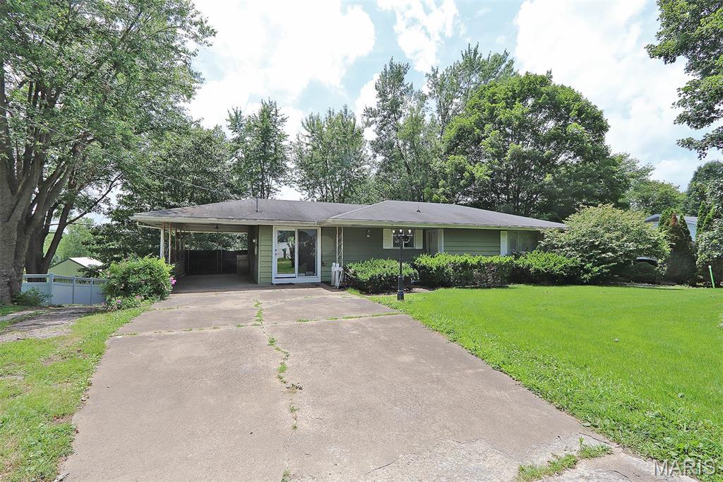 This 3 bed 2 bath ranch home sits on a spacious & 1/2 acre+ lot in Jackson School District, offering room to stretch out, grow, and enjoy small-town living outside the city limits.  Step inside to find the original hardwood flooring preserved beneath the carpet, ready to shine again. The cozy den features a gas log fireplace, perfect for movie nights or morning coffee.  The full finished walkout basement is a standout bonus—complete with a kitchenette, bedroom, full bath, and private access. Whether you need space for a parent, a college kid, a teenager, or a rental-style efficiency setup, this lower level delivers flexibility and privacy.
  For all your hobbies, storage, and tinkering needs, you’ll love the workshop/garage area in the basement, PLUS a detached 24x24 shop/garage out back. Vehicles, tools, toys—bring them all.  The large lot provides plenty of outdoor usable space with room for gardens, pets, play, and future projects.  Updated electric and a new breaker box.  Brand new sewer lines.