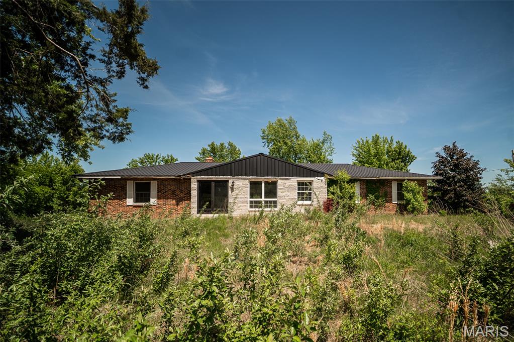 3 bed, 2 bath ranch on 6.1 acres offering a great opportunity for investors, homesteaders, or buyers looking to build equity through cosmetic updates. With 1,684 sq ft, this home provides a functional layout and solid footprint ready for modernization. The interior primarily needs aesthetic improvements, making it ideal for those wanting to customize finishes while adding value. A durable metal roof adds peace of mind on a key exterior component.

The property truly shines with its land and outbuildings, featuring a large barn and additional outbuilding, perfect for livestock, storage, workshop use, or hobby farming. The expansive acreage is dotted with mature trees, creating a private, rural setting ideal for a small homestead or country retreat. Both bathrooms are full baths, supporting a practical and flexible layout.

Sold as-is, this property offers strong potential in a peaceful setting with room to expand, improve, and make it your own.