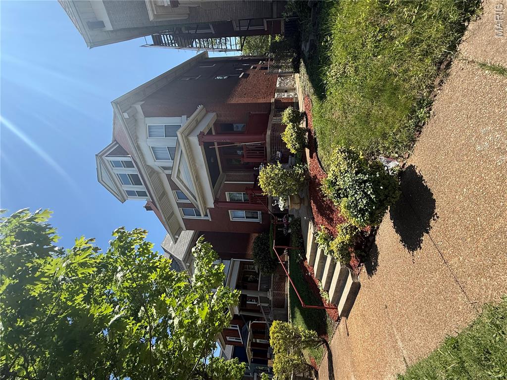 Step into the timeless charm of 5186 Vernon Ave, a beautifully preserved 3 story brick home built in 1906 and filled with original character. The moment you enter, the grand staircase, rich woodwork, and classic 5 panel doors set the tone for a home crafted with true historic detail. Sunlight pours through the bay windows, highlighting the original fireplace grates and mantels that anchor the living spaces with warmth and authenticity. The updated kitchen blends modern convenience with vintage appeal, featuring a decorative tin ceiling, ample cabinetry, and easy access to the back deck overlooking the fenced yard. Hardwood flooring flows throughout, and some rooms feature beamed ceilings that add architectural interest. The upper levels offer flexible living, including a third floor suite with its own kitchen—a rare feature that opens the door to guest quarters, multigenerational living, or potential income producing use (buyer to verify local requirements). Enjoy morning coffee or evening relaxation on the walk out upper level balcony, with views of the private backyard. A detached 2 car garage adds valuable convenience in the city. With 3 bedrooms, 3 full baths, and a layout that blends historic craftsmanship with thoughtful updates, this home delivers a truly special living experience for anyone who appreciates character, space, and opportunity.