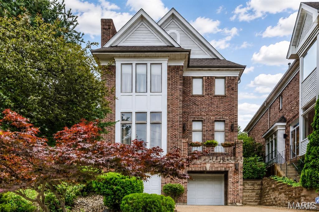 Ideally located just blocks from downtown Clayton, this side-entry brick home offers timeless architecture paired with contemporary flair. A dramatic two-story foyer sets the tone, opening to a welcoming great room anchored by a fireplace with distinctive bluestone detailing. Architectural ceilings throughout the main level add depth and character, while the well-equipped kitchen features granite countertops, a breakfast bar, a Sub-Zero refrigerator, and JennAir double ovens, a range, and a dishwasher. The adjoining bay-window breakfast area is filled with natural light and overlooks the beautifully landscaped yard. Step outside to the spacious new deck and patio—perfect for entertaining or relaxing in a private outdoor setting. Upstairs, you will find three generously sized en-suite bedrooms, including a serene primary suite with an impressive walk-in closet. The primary bath includes a floating double vanity, a separate shower, a Jacuzzi tub, and a skylight for natural light above. The finished lower level expands the living space with a large family room and a full bath—ideal for guests, recreation, or a home office. Designed with long-term accessibility in mind, the home includes a dedicated elevator shaft serving all levels, allowing for future elevator installation. A three-car tandem garage completes the home, offering exceptional storage and everyday convenience.

*PHOTOS HAVE BEEN DIGITALLY STAGED TO EFFECTIVELY SHOWCASE POTENTIAL LAYOUTS AND USES OF THE SPACE