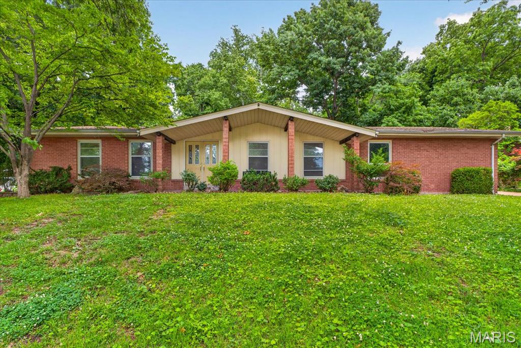 Welcome home to this beautifully appointed full-brick residence in a prestigious subdivision, set on a private sprawling almost half-acre lot with a side-entry 2-car garage and a 32.5-foot in-ground pool. Designed for both comfort and style, the home offers a family room anchored by a dramatic floor-to-ceiling brick fireplace, separate living and dining rooms and 1,766 square feet on the main level plus a finished lower level including layout for a full bath with some fixtures already in place.  The kitchen features generous counter space, pretty tiled backsplash, abundant cabinetry, double ovens, gas stove top and offers picturesque views of the pool and backyard. The spacious primary suite includes double closets, hardwood floors beneath the carpet, and a private bath boasting a new shower. Additional highlights include main-floor laundry, low-maintenance exterior finishes and attic fan.