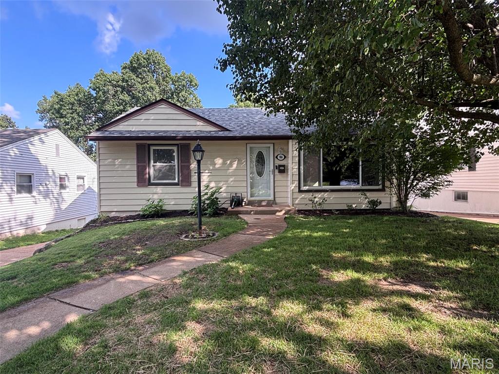 Charming Crestwood bungalow in a quiet, established neighborhood. This well-maintained home features polished hardwood floors, abundant natural light, and a comfortable layout ideal for first-time buyers or downsizers. The living room includes a wood-burning fireplace, and the adjacent bedrooms offer bright, airy spaces with neutral finishes. The home includes a modern bathroom with updated fixtures, tile surround, and a clean, contemporary vanity. The kitchen and main living areas flow easily, creating a welcoming environment ready for your personal touches. A major highlight is the partially finished walkout basement, offering exceptional potential for future expansion—family room, additional bedroom, workshop, or storage. A convenient 2-car parking pad is located at the rear of the home.  Mechanical updates include a new roof, updated HVAC system, and a new sewer lateral, providing peace of mind for years to come. Outside, enjoy a large fenced-in backyard with plenty of room for gardening, pets, or outdoor entertaining. The property is move-in ready, sits on a quiet street with well-kept homes and easy access to Crestwood amenities, parks, and schools.