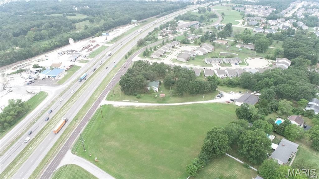 High visibility commercial land fronting on Interstate Hwy. 70.  Tract is 6.01 acres per the county records.  Land consist of older two story home and automotive shed on the backside of property.  Property is located on the north side of Hwy. 70 in between the main Wentzville overpass and the new one that is currently under construction.  There is approximately 550 feet of outer road frontage. Owners are willing to split the property and sell off 3.57 acres which will be advertised in a separate listing.  Property is subject to zoning approval. Location: City, High Traffic, Hwy/Interstate Frntg