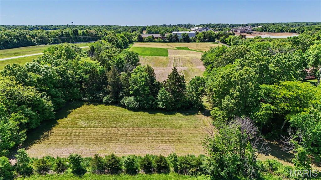Discover the perfect blend of privacy, beauty, and convenience with this stunning 8.4 acre tract in Defiance. Mostly open and framed by tree-lined borders, this picturesque property offers beautiful views and the ideal setting for your future home, private estate, hobby farm, or equestrian retreat. With unrestricted acreage and plenty of usable ground, there's room for horses, livestock, gardens, outbuildings and more. Enjoy the peaceful country atmosphere while still being just minutes from Lake Saint Louis shopping, dining, and convenient Highway 40 access. Outdoor enthusiasts will love the close proximity to Broemmelsick Park and Busch Wildlife with miles of scenic hiking and riding trails, fishing and recreation, along with the local wineries and rolling countryside. Don't miss out on this exceptional property that offers the flexibility and lifestyle you've been searching for. Septic and Well Required. Electric fronts the property. Virtual tour is a concept of a home being built on the raw land . If desired: Dividing the property may be possible, but would require county approval of zoning change from ag to rural residential.