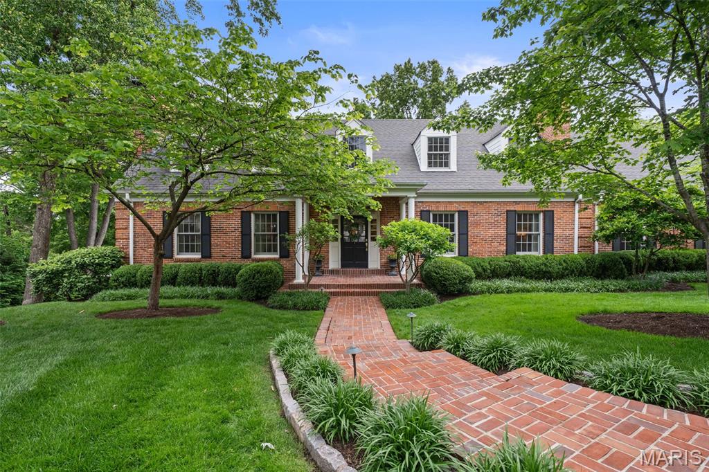 Tucked away in a quiet neighborhood in the heart of Ladue, this beautifully designed home offers an exceptional blend of style, comfort, and thoughtful renovation with a mid-century modern flair. Featured in St. Louis Magazine for its impressive design and updates, the home showcases a classic center hall floor plan reimagined with fresh, sophisticated spaces throughout.  A gracious entry welcomes you inside, flanked by a large living room with a handsome fireplace on one side and a spacious dining room on the other. The dining room opens seamlessly to the recently remodeled kitchen, complete with a large center island, top-of-the-line appliances, and an easy connection to the main living spaces.  Just beyond, a stunning breakfast room atrium features a wall of windows overlooking the pool, hot tub, and nearly one-acre wooded property. Open to the expansive family room with a bar and French doors leading to the deck, this area creates an effortless flow for everyday living and entertaining. The main level also includes a generous guest suite with a remodeled bath, a stylish powder room, a large mudroom, and garage space. Upstairs, the charming primary suite features darling dormers and a crisp bath, along with two spacious guest bedrooms that share a hall bath. The walkout lower level adds incredible flexibility with a huge recreation room, exercise room, office, additional sleeping area option, kitchenette, and full bath, all with direct access to the pool and hot tub. A rare Ladue offering with privacy, design, mid-century inspired character, and beautifully livable spaces inside and out. Please note that the property is not in any flood zones, Zillow/Realtor is incorrect.