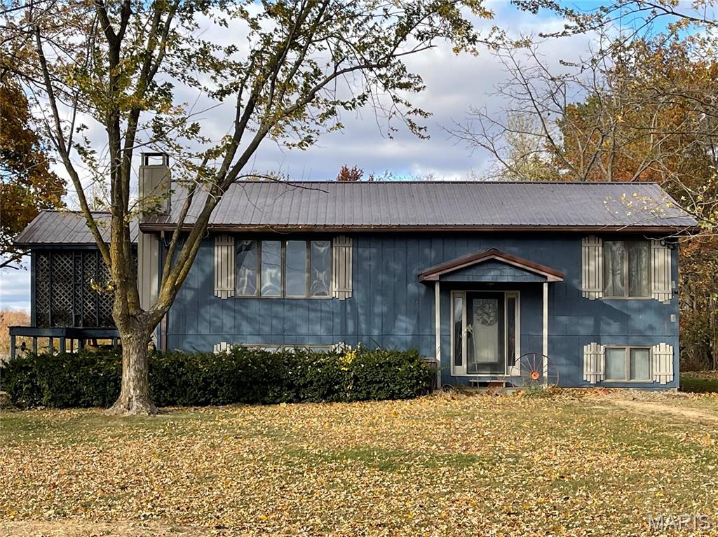 Enjoy peaceful country living with this charming 4-bedroom, 2-bath home situated on approximately 3 acres featuring a stocked pond and a 24’x30’ attached garage—perfect for storage, hobbies, or a workshop.

A newer tin roof provides long-term durability and peace of mind. Inside, the split-level layout provides ample space for the entire family. The upper level features a spacious great room that opens to a functional kitchen with freshly painted cabinets and a cozy dining area. Two comfortable bedrooms and a full bathroom with dual sinks complete this floor. Step outside onto the private deck, enclosed with lattice for shade and relaxation.

The lower level offers a large open area ideal for entertaining, a family room, or a recreation space. This level also features two additional bedrooms, one of which serves as the primary suite, complete with a large closet and a beautifully finished bathroom featuring a tile shower.

With both levels providing functional living areas, this home offers flexibility and comfort for everyone. Enjoy your own slice of the countryside while being just minutes from all the amenities of Bowling Green.