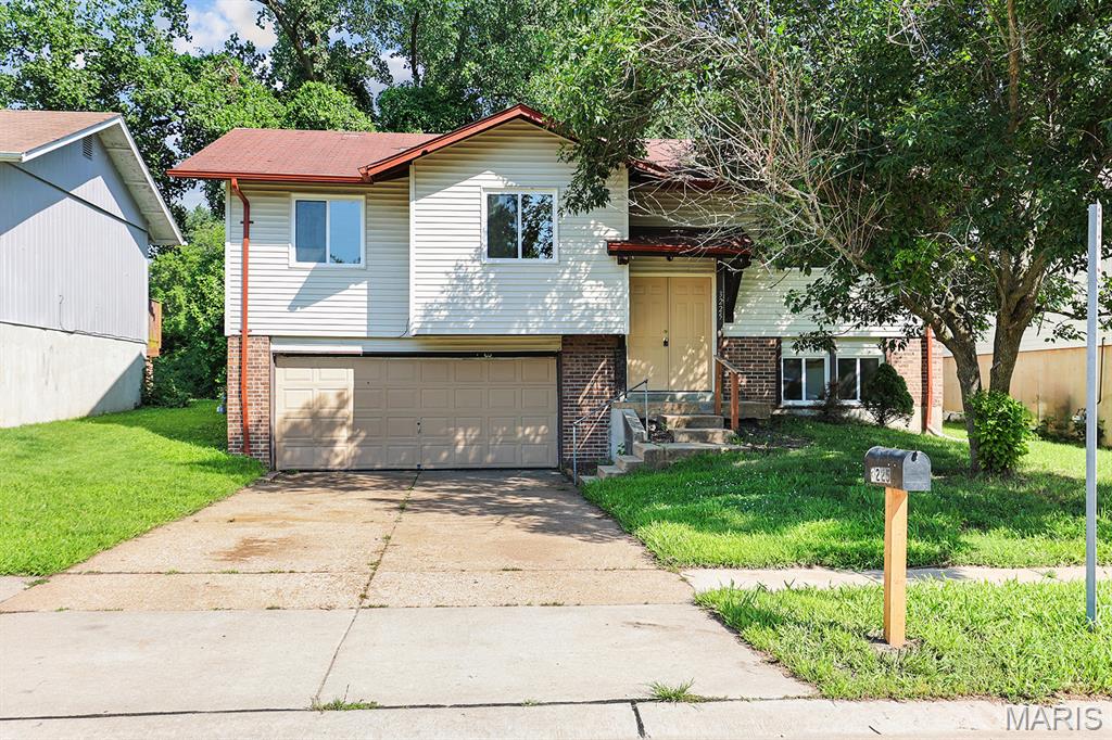 Welcome to 3225 Chicory Creek Drive, a split-level home located in a St. Louis County neighborhood near Brown Elementary. Offering three bedrooms, two full bathrooms, and living space on two levels, this home is ready for its next owner. The spacious primary suite features its own private full bathroom. The home's functional layout includes bright living areas and a finished lower level that offers additional space for a family room, recreation area, home office, or entertaining guests. Outside, you'll find a generous backyard with plenty of room for outdoor activities. An attached two-car garage provides convenience and additional storage space.