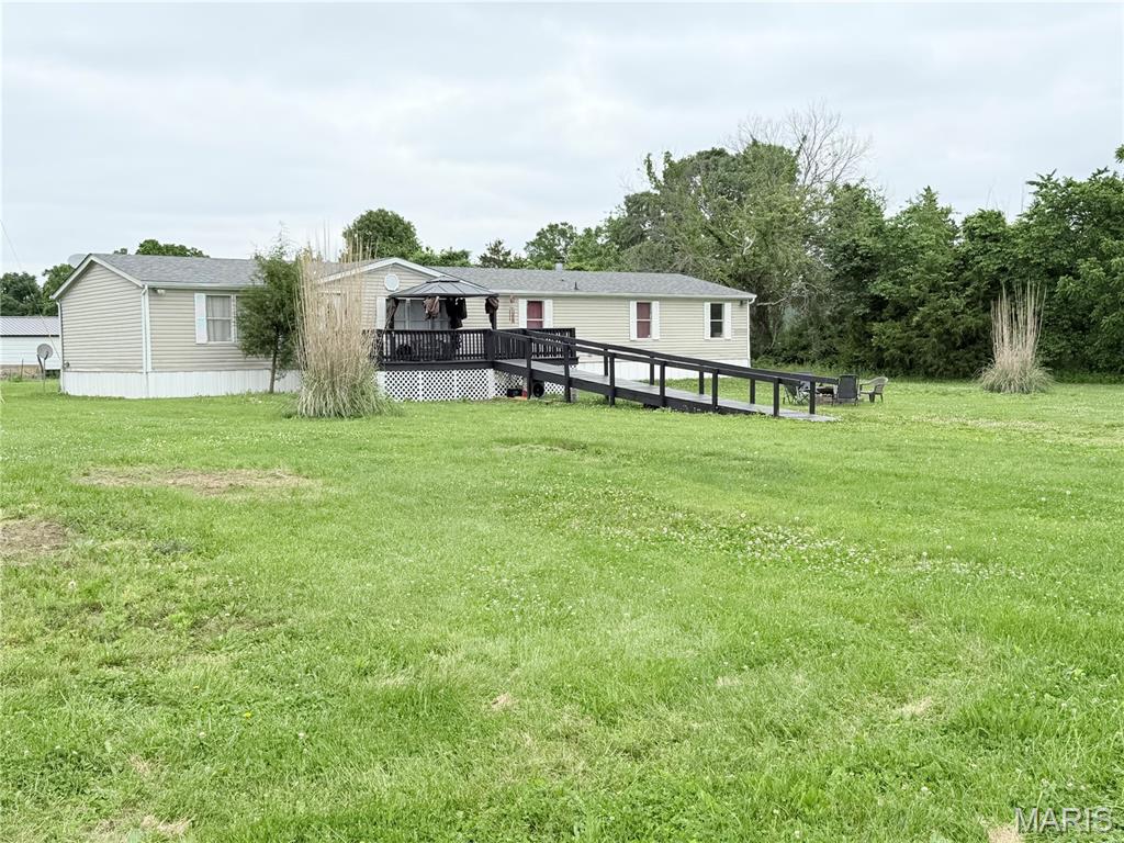 Discoverer this spacious four-bedroom two bath mobile home located outside of town, offering the perfect balance of peaceful living convenience! Step inside to find a cozy living room complete with a beautiful fireplace, perfect for relaxing evenings at home. As you arrive. You’ll immediately notice the stunning oversized deck leading to the front entrance, creating a welcoming outdoor space, ideal for entertaining or enjoying the scenery. An additional side deck provides easy access to the side or backyard area. Situated on a large yard with plenty of room to enjoy outdoor activities. This property offers comfort and country style living while still being just minutes from local amenities, shopping, and dining. Don’t miss out on your chance to see all this property has to offer call today to schedule your private showing. Property to be surveyed on 05/22/2026