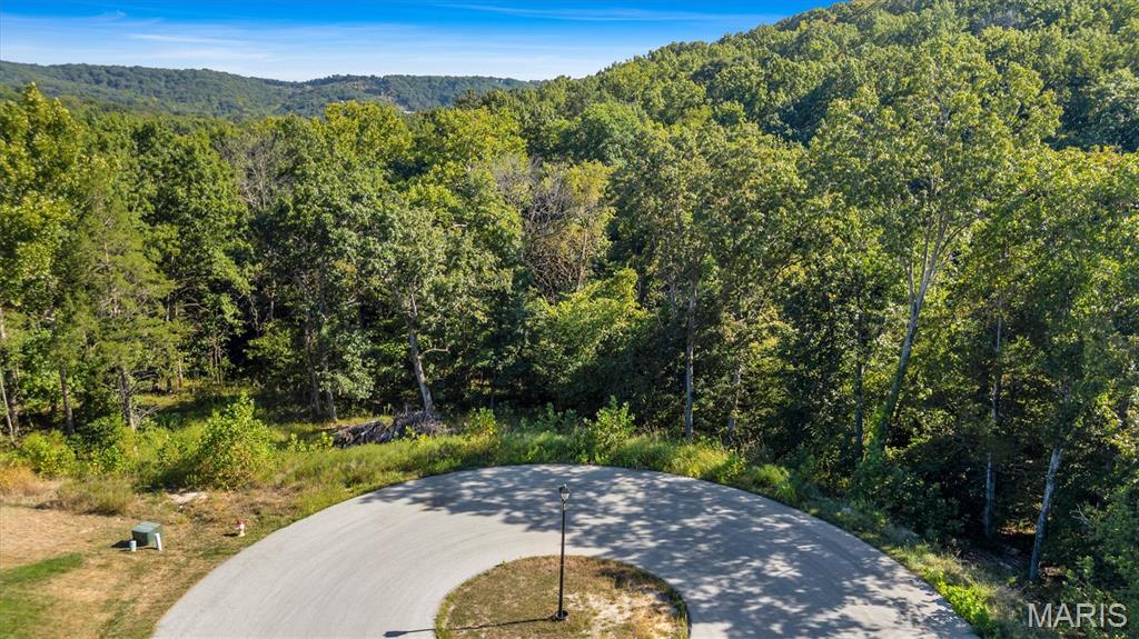 Your dream home begins here! Nestled in the highly sought-after Red Oak Valley subdivision, this 1.6+/- acre wooded lot offers the perfect blend of privacy and convenience. Imagine designing a custom home surrounded by trees, yet just minutes from everyday essentials and major highways (21, 30, M, 55 & 270).
This premium homesite is already equipped with public water, sewer, natural gas, high-speed internet, cable, asphalt roads, and streetlights, giving you the modern comforts you need in a scenic, serene setting. Sought after Seckman High School, Antonia Elementary & Middle, and builders will appreciate that site-specific custom plans are available to jumpstart your vision.
Don’t just buy land—create the lifestyle you’ve always imagined in a neighborhood that feels like home from the start. Site specific building plans are available!