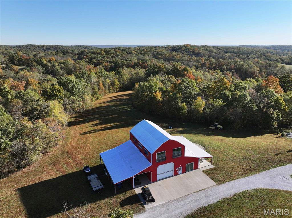 Located just 6 miles east of Perryville off Hwy E, at 555 Morning Star Circle, Perryville, MO 63775, this diverse 113.68± acre recreational property offers a rare blend of natural beauty, income potential, and high-quality improvements.

This property features a custom-built Barndominium overlooking a cleared potential lake site, with approximately 2,400 sq. ft. of living space. The craftsmanship and design are second to none, and the home currently serves as a successful Airbnb rental.

Also included is a 5-bedroom, 1-bath, 1,845 sq. ft. farmhouse that’s been recently updated with new electrical and plumbing. The farmhouse currently generates steady rental income from a long-term tenant.

Enjoy panoramic views, underground caves, and a natural spring-fed swimming hole along Cinque Homes Creek. Miles of trails wind through the timber, offering excellent hunting and exploration opportunities.

The property is fenced with custom pipe fencing and has a gated entrance, making it ideal for livestock or equestrian use. A recently added campground area brings additional income potential, complementing the farmhouse rental and Airbnb operations.

This one-of-a-kind property truly showcases the beauty and diversity of Southeast Missouri—perfect as a private retreat, income-generating investment, or your next dream homestead.
