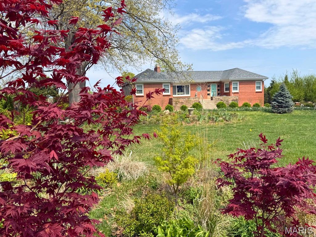 12 years of thoughtful design & meticulous attention to detail have transformed this extraordinary property into a true private enclave in the heart of town. Centered on a beautifully landscaped 1.18-acre lot, this re-imagined home offers the rare combination of peaceful seclusion & unbeatable convenience - just minutes to everything.
More than $240,000 in upgrades/improvements have been invested into this home - not including the costs of landscaping, trees, gardens, & water features - these grounds feel like a private botanical retreat. 
Surrounded by towering oaks, arborvitaes, pines & spruces, this property feels wonderfully tucked away. A Ginkgo-lined driveway leads towards the Japanese maple & hosta garden tucked under a canopy of oaks, beneath which a dramatic boulder waterfall cascades down a creek into & tranquil pond. The expansive, gently sloping rear yard offers endless possibilities - the perfect setting for a possible future sun-shelf in-ground pool just off the oversized rear deck.
The welcoming front porch stretches an impressive 12’ x 28’, and the new red quarry tile porch floor is just stunning!
Off the kitchen, the rear 25’ x 11’ deck overlooks the lush, private backyard, & trex decking & white PVC railings provide stylish, low-maintenance living.
The oversized tandem 2-car garage offers ample room for vehicles, tools & garden equipment, while the insulated concrete walk-out “bunker” beneath the front porch provides more bonus storage or gym space.
The finished basement rec room comes complete with large windows, a wall of closets & a hidden vintage bank-style safe.
This home was truly designed for entertaining - spacious rooms, seamless flow & a rear parking pad can accommodate at least 5 cars.
Inside, timeless craftsmanship blends beautifully with modern updates. Guests are welcomed by a ceramic tile foyer with plaster cove ceiling, before stepping onto gorgeous oak floors that flow into the expansive living room. Oversized front windows & a rear bay window flood this space with tons of natural light, while stunning plaster work, an ornate tray ceiling, medallions & original neon cove lighting preserve the home’s distinctive mid-century charm. A newly installed direct-vent gas fireplace adds warmth & ambiance.
The adjoining dining room continues the elegance with arched doorways, sophisticated lighting & architectural details that showcase the craftsmanship rarely found today.
The kitchen has been completely re-imagined with custom cabinetry, soft-close drawers, pull-out storage - pairing beautifully with modern appliances, designer tile work, quartz countertops & abundant LED lighting. The showstopping blue quartz waterfall center island with downdraft gas cook top is the dramatic focal point.
The bathroom & closet renovation transformed outdated spaces into two luxurious modern baths & a spacious walk-in primary suite closet. With stylish tile work, illuminated mirrors, blue tooth speaker exhaust fans & designer finishes, these spaces offer a spa-like experience. The east private primary suite is a true retreat, thoughtfully separated from the other west wing bedrooms.
Two bedrooms currently function as home offices, while the 4th bedroom is currently a dedicated home theater, complete with a platform for stadium seating & an 82” wall-mounted television that stays with the home.
And the upgrades continue: top-of-the-line tilt-in windows, rebuilt deck, new vertical siding, updated boiler & chimney liner, backup furnace & A/C, 2 new patios, new shingled roof, new fireplace hearth & so much more. Every improvement has been carefully considered to enhance comfort, efficiency, style & livability.
This is more than just a home - it’s a one-of-a-kind property designed for gathering, relaxing, entertaining & making memories. A truly special opportunity for the next owners to simply move in & enjoy everything that has already been lovingly created. Passed Occupancy Inspection.  Owner/Agent.
