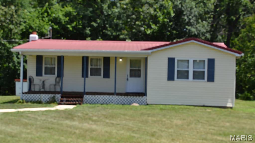 Move in ready on 4+ acres  available for your viewing now. Property totally updated over the last 4 years or less including new HAVC, wiring including panel, paint, flooring, lighting, back deck, carpeting, 40gal hot water heater, plumbing, metal roof resealed. Huge front yard with plenty of room to build a garage or a horse barn. No restrictions so build what you want and bring your horses on out. Sets far enough from highway that you do not hear the noise. One way in and out assures you have the privacy you want. Set up your showing today.