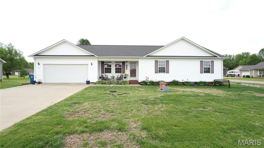 Located just outside city limits in a quiet, peaceful setting, this beautifully updated 3-bedroom, 2-bath home offers the perfect blend of comfort, space, and modern style. Sitting on a desirable corner lot, the home features a semi-open floor plan designed for both everyday living and entertaining. The spacious living area is warm and inviting, highlighted by an electric fireplace with a custom mantle—perfect for cozy nights at home. Just off the main living space, you’ll find a separate dining room ideal for family meals or hosting guests. The kitchen is move-in ready and fully equipped with all appliances, offering both convenience and functionality. Throughout the home, you’ll appreciate the updated LVP flooring and modern light fixtures that give the space a fresh, clean feel. The primary suite offers a relaxing retreat with a walk-in closet, while the additional bedrooms provide plenty of space for family, guests, or a home office. Step outside to enjoy the backyard, complete with a wooden deck—perfect for grilling, entertaining, or simply unwinding. The 2-car garage adds extra storage and convenience, and being an all-electric home helps keep things efficient and simple. If you’re looking for a move-in ready home in a quiet neighborhood with space to spread out, this one checks all the boxes.