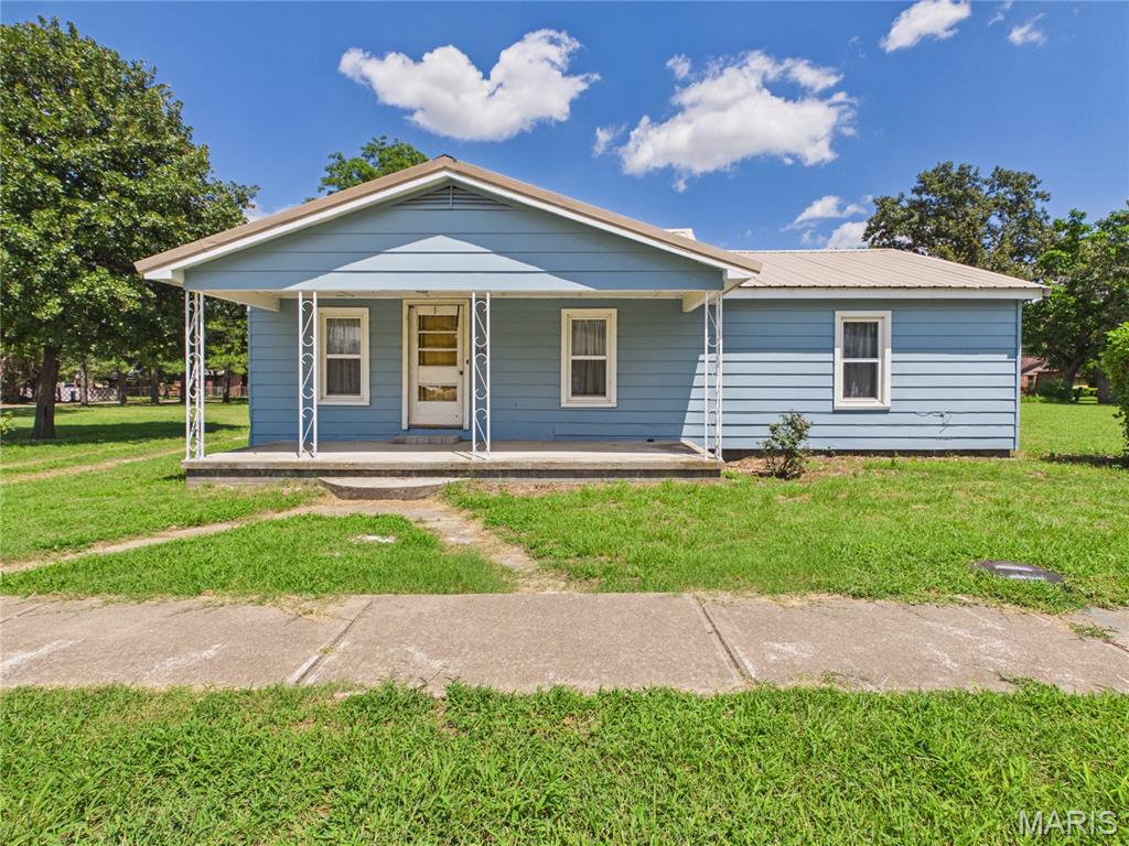 Charming 2 bedroom, 1 bathroom bungalow offering a fantastic opportunity for buyers looking to add their personal touch. Situated on a 4 city lots, totaling 0.64 acres in Bernie, this property features 1,214 square feet of single level living space with low maintenance vinyl siding and a durable metal roof.

Inside, you will find a spacious living room and an eat in kitchen, all updated with durable luxury vinyl plank flooring throughout the main level. Practical additions like a dedicated main floor laundry room and an extra utility space make daily chores a breeze. The exterior includes a level yard with a few mature trees, a classic front porch perfect for relaxing, and an outdoor shed for extra storage.
Whether you are looking for a manageable home to customize or a solid investment property, this home has incredible potential. Conveniently located within the Bernie R-XIII school district.