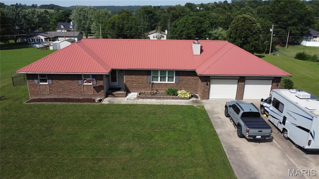 Welcome to 24450 Sidney Road in Waynesville! This well-maintained 4-bedroom, 3-bath home sits on a full acre and offers the perfect combination of space, functionality, and updates, making it ready for its next owners.

Inside, you'll find a spacious living room featuring a cozy wood-burning fireplace with custom built-ins, creating the perfect gathering space for get-togethers. The formal dining room offers plenty of room for entertaining, while the kitchen includes appliances that are approximately two years old. The washer and dryer also stay with the home, adding even more value. In addition to the four bedrooms, you'll find a versatile non-conforming room that could be used as a home office, hobby room, game room, or whatever best fits your needs.

Over the past few years, several major improvements have been made, including new vinyl windows, insulated vinyl siding, a new vinyl sliding glass door with UV protection, and a newer storage shed that will remain with the property. These updates help improve energy efficiency while reducing exterior maintenance.

Step outside and enjoy the large, fully fenced backyard with plenty of space to relax, entertain, or simply enjoy the outdoors. The full-acre lot provides room to spread out, while the storage shed offers additional space for lawn equipment, tools, or seasonal items. You'll also appreciate the RV hookup, providing added flexibility for an RV, EV, or visiting guests.

If you're looking for a move-in ready home with thoughtful updates, flexible living space, a large fenced yard, and practical features both inside and out, this is one you won't want to miss. Schedule your private showing today!