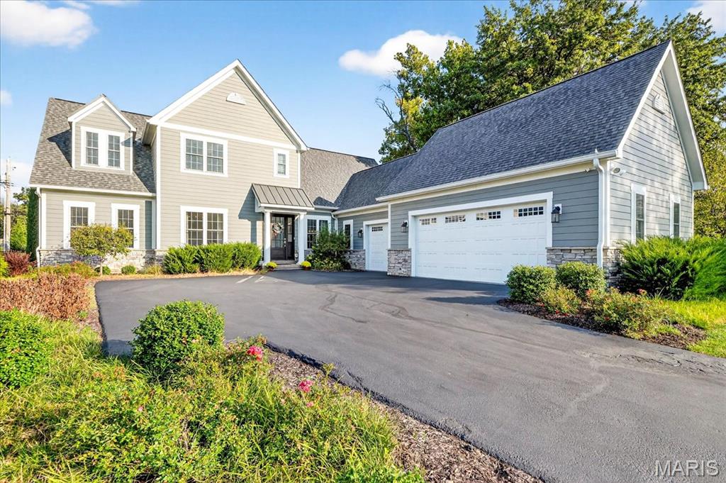 Tucked away on a private cul-de-sac, this exceptional custom-built home blends modern elegance with everyday comfort—all just steps from Ladue & Frontenac shops, restaurants, and schools. Built in 2021, it offers a bright, airy layout with soaring ceilings and thoughtful craftsmanship across three finished levels. The heart of the home is the gourmet kitchen, featuring high-end finishes and stainless steel appliances including a built-in ice maker and microwave. The spacious breakfast room has an effortless flow into the inviting great room with its cozy fireplace. The designer light fixtures throughout add a touch of sophistication to the home. The main floor primary suite is truly a retreat, featuring a luxurious spa-style wet room with multiple shower heads and sprayers, dual vanities and two generous walk-in closets. The bathroom is enhanced by illuminated mirrors, abundant natural light, and a serene atmosphere that elevates the everyday routine into a spa-like experience. The main floor also offers a private office or additional bedroom with closet. Upstairs, you’ll find a spacious ensuite bedroom plus two additional rooms joined by a stylish Jack and Jill bath. The lower level is designed for fun and functionality—complete with a media lounge, fitness area, and an impressive bar with custom shelving, beverage cooler, and an additional built-in dishwasher & ice maker! The spacious 3-car heated garage features an epoxy floor and high-amp Tesla charger. Additional highlights include two water heaters, two zoned heating and air conditioning units, and a security system already installed and ready for activation. Outside, you’ll find the beautifully maintained landscaping and irrigation system. A perfect blend of style, quality, and location, this stunning home is move-in ready!