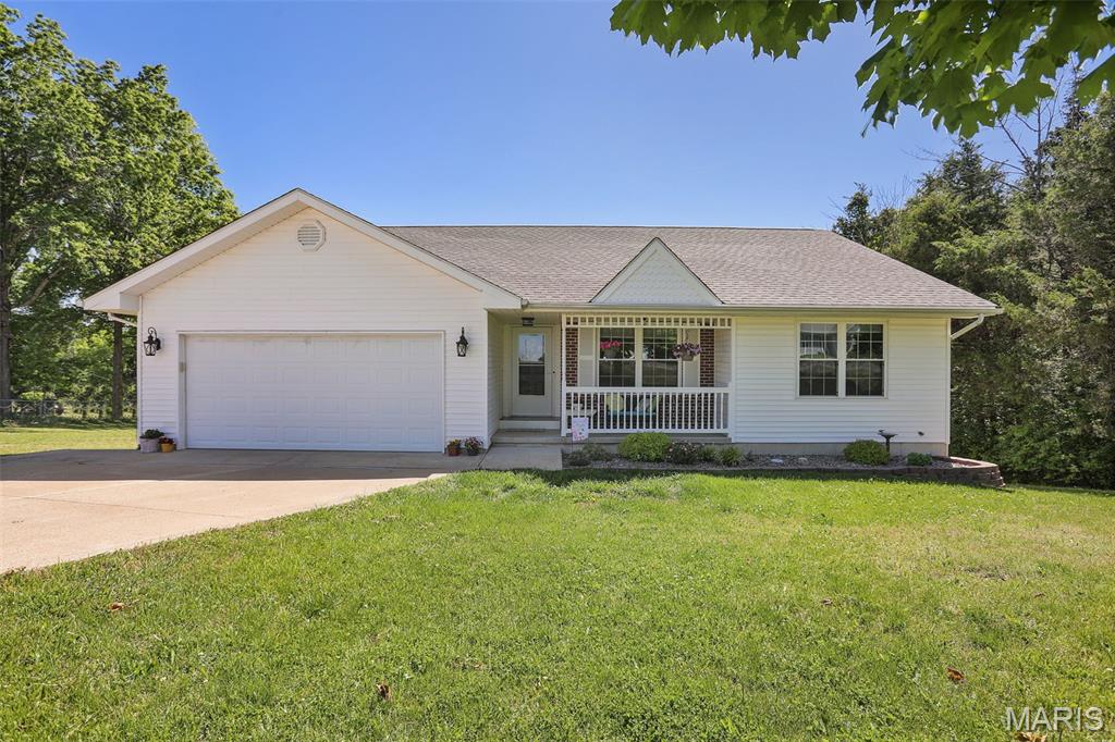 Adorable 3 bedroom, 3 bath home just outside of city limits!  The main floor features an open kitchen, a main floor laundry room, and spacious living room with gas fireplace! Large composite deck off of the dining area is convenient for hosting and entertaining guests. The bedrooms on the main floor are all nice size and feature newer carpeting. Large windows allow for plenty of natural lighting throughout. The primary bedroom has an en-suite with a walk-in shower and oversized vanity. In the lower level you will find plenty of space to spread out! Perfect for a family room, play area, or work space. Outside you will find a partially wooded yard that allows for some privacy on one side, and a small storage shed that is perfect for gardening tools and misc items!  Don't let this one pass by, schedule your showing today!