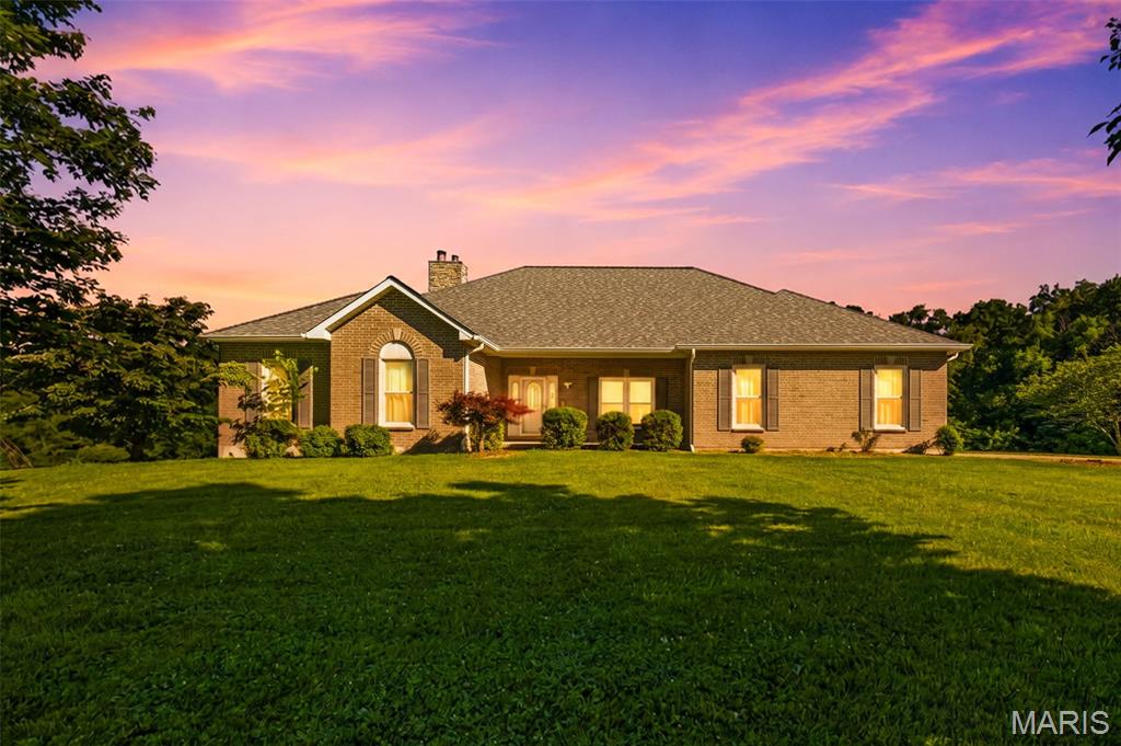 Country Living at Its Finest on Nearly 11 Acres!

Welcome to this stunning custom-built atrium ranch nestled on 10.98 picturesque acres in northern Lincoln County. Offering over 3,400 square feet of living space, this one-owner home combines privacy, comfort, and functionality just minutes from Highway 61. Featuring 3 bedrooms, 3.5 bathrooms, and an open-concept floor plan, the main level showcases a spacious great room with soaring vaulted ceilings, a floor-to-ceiling wall of windows, and a beautiful brick fireplace overlooking the peaceful wooded backdrop and abundant wildlife.

The heart of the home flows seamlessly through the kitchen, dining area, breakfast room, and inviting hearth room with hardwood floors and a second fireplace. Step outside to the covered deck and enjoy breathtaking views of your private country setting.

The finished walk-out lower level is designed for entertaining, complete with a second full kitchen, large dining area, game room, family room, full bath, and a third fireplace. Ample unfinished storage space provides room for all your seasonal items and equipment.

Outside, you'll find two impressive outbuildings—a 30' x 50' building and a 30' x 60' building with concrete floors and electric—perfect for hobbyists, contractors, boat and RV storage, equipment, or workshop space. The gently rolling acreage includes a mix of open ground and wooded areas, creating the ideal setting for recreation, hunting, or simply enjoying the outdoors. Built in 2000, this exceptional property offers the rare combination of a spacious custom home, acreage, and versatile outbuildings in a peaceful rural setting.