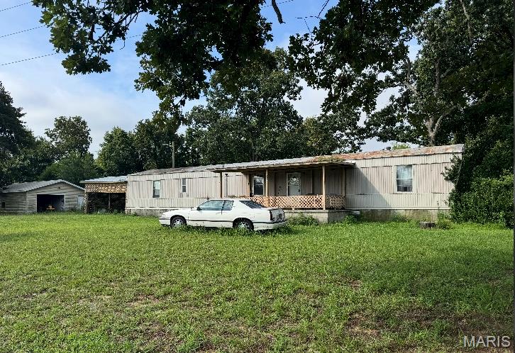Looking for peaceful country living with room to make it your own? This 1-acre property just off Highway 77 in Benton, MO offers endless potential! Featuring a manufactured home, a spacious shop, and a covered carport, there's plenty of space for hobbies, storage, or outdoor projects. Whether you're searching for an investment opportunity, a fixer-upper, or a quiet place to call home, this property is full of possibilities. Being sold AS IS.