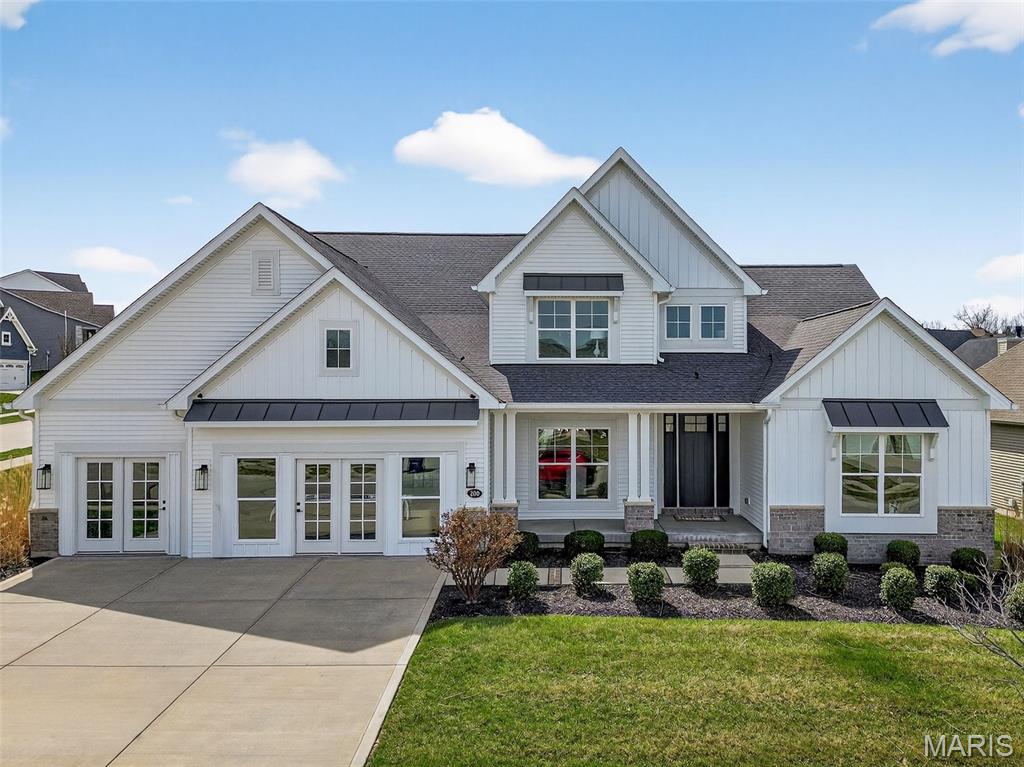 Award winning builder display home now available for immediate move in!  This stunning, 1.5 story home will wow you with an amazing use of space and the on-trend finishes and features that todays buyers are looking for.  The exterior is captivating with a clean, modern farmhouse-style exterior, architectural shingles, and oversized 3 car garage, professional landscape, lawn irrigation and a covered patio.  Features include an impressive designer Kitchen, large island, seating bar, quartz countertops, stainless steel appliances, double oven, gas cooktop, chimney style range hood, tile backsplash, walk in pantry, 9 foot wide sliding door opening to the covered patio,  luxury vinyl plank flooring throughout the main, 9 foot ceilings with 11 foot in the Great Room, gas fireplace with stone surround, built in bookshelves, Great Room window wall, entertainment bar/beverage center with accent wall, butlers pantry, Dining Room, Office with a beamed ceiling, 8 foot tall Entry and interior doors, a boot bench and Powder Room off of the Owners Entry, main floor Laundry, MAIN FLOOR PRIMARY SUITE with bay window, shower with seat in the Primary Bath with raised height double bowl vanities, luxury plank tile flooring, walk in closet and a huge linen closet.  There is a popular side staircase, wrought iron spindles, exposed stair treads, an upstairs Loft area, three large secondary bedrooms (one with private bath), walk in closets in every bedroom, two full bathrooms, and a large, step-up Bonus Room.  Additional features include dual HVAC, two electric panels, Low E windows and a neutral color palette.  The basement has a tall pour, an egress window and a bath rough in for an easy future finish if desired.  Windsor Park is a lovely community in Lake St. Louis with walking paths, a picnic area, two lakes and easy access to Highways 40/61, 364 and 70.  This incredible home is a must-see!
