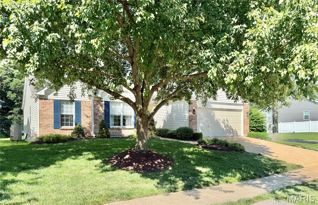 Welcome to a rare and exceptional opportunity to own a detached villa featuring four bedrooms on the main level, a truly hard-to-find layout.  Step inside to discover a bright, open floor plan enhanced by beautifully updated hardwood flooring in the great room and dining area, and comfortable carpeting in the bedrooms. The spacious great room flows seamlessly into the dining area and an updated kitchen, offering abundant cabinetry and storage, perfect for everyday living and entertaining.  Enjoy the convenience of main-floor living, including a laundry room and a generously sized primary suite featuring brand new carpeting. a walk-in closet and a full bath with a soaking tub, separate shower, and double vanity. Three additional main-level bedrooms provide flexibility for family, guests, or a home office.  Relax and unwind in the three-season room, ideal for enjoying peaceful mornings or evening gatherings.
Additional highlights include a two-car attached garage with a new garage door opener with a battery backup, and a full, unfinished lower level offering incredible potential for expansion, with ample space and a rough-in for a future bathroom.  This beautiful home offers carefree living, with lawn care and snow removal included in the low monthly fee of just $232.  Conveniently located near Highways 270 and 55, you’ll enjoy easy access to shopping, dining, and commuting routes.