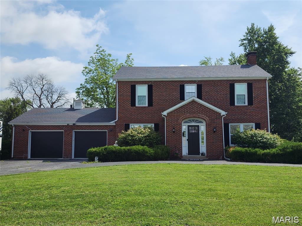 A stunning full brick home with tons of curb appeal. Completely remodeled with quality finishes. Entering the foyer you are greeted by original hardwood floors and spacious dining and living room spaces. The living room features a functional wood-burning fireplace and an attached sun room. The kitchen has beautiful thinscape counters with tile floor and stainless steel appliances. 3 bedrooms upstairs with full guest bathroom and a master suite featuring a full bathroom with sunken soaking tub and separate shower. Lower level includes half bath, laundry area, family room and a sleeping area for a 4th bedroom... This home is on an oversized corner lot with attached 2 car garage and fenced back patio area.