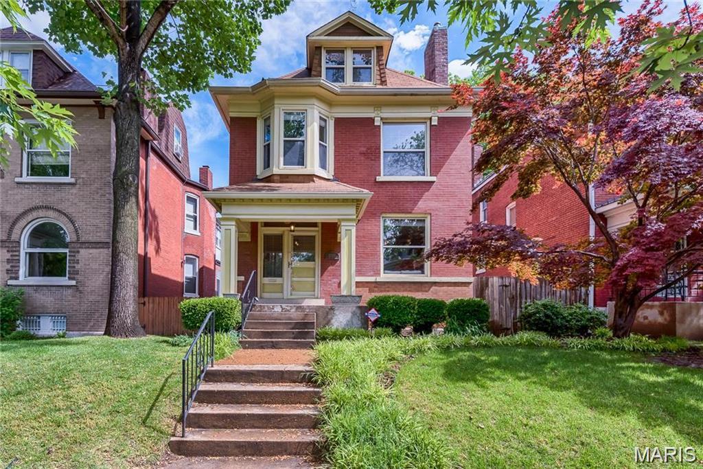Located just two blocks from Tower Grove Park and one block from the vibrant South Grand Business District, this beautifully maintained historic home combines timeless character with modern convenience in the heart of Tower Grove South. A grand formal entry welcomes you into a home filled with original hardwood floors, crown molding, pocket doors, and a gas fireplace that anchors the elegant living room. The formal dining room flows seamlessly into the updated kitchen featuring custom 42-inch cherry cabinetry, granite countertops, breakfast bar seating, pantry storage, and recessed lighting. Offering 4 bedrooms and 3 full baths across three finished levels, the home provides exceptional flexibility for today’s lifestyle. The second floor features a spacious primary suite with double vanities, separate shower, and jetted tub, along with two additional bedrooms and a second full bath. The third floor serves as a private fourth-bedroom suite complete with custom built-ins, window seat storage, a recently added full bathroom, and a dedicated mini-split system. Outdoor living is equally inviting with a newly rebuilt rear porch overlooking a beautifully landscaped backyard and aggregate patio. A detached two-car garage, built in 2002, provides valuable off-street parking and storage. With historic charm, generous living space, and unbeatable walkability to Tower Grove Park, South Grand restaurants, coffee shops, and neighborhood favorites, this is a rare opportunity to own a classic St. Louis home in one of the city’s most sought-after neighborhoods.