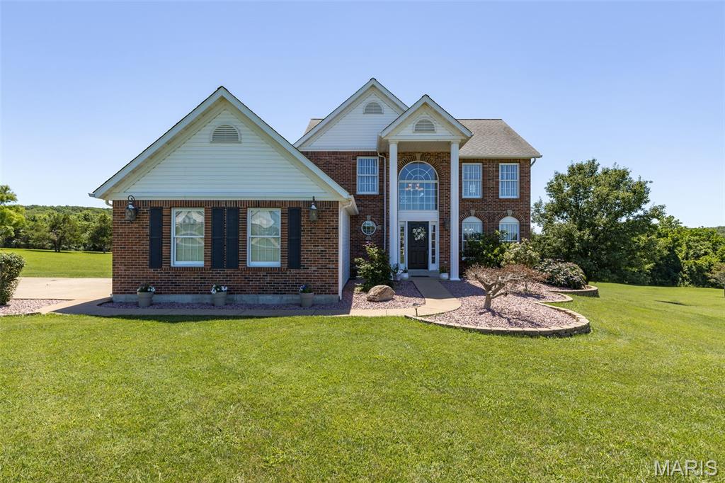 Discover this magnificent 2-story home on 3 acres in a gated community (the gorgeous Winchester Hills) that exemplifies an attractive and well-maintained living environment. The 2-story entry foyer and central staircase make a bold statement here. The Owner's Suite on the main level invites you in with vaulted ceilings, so much natural light with a beautiful wooded park like view out back and a large bath boasting a corner jet tub, dual vanities, and separate shower, providing a spa-like experience within the comfort of your own home. The kitchen presents peninsula dining, custom millwork, stainless steel appliances seamlessly integrating into a formal dining room one way, and an open-plan living room with tons more natural light and a wood burning fireplace the other way, fostering an inviting atmosphere for both everyday living and entertaining. The dedicated main floor laundry room enhances daily convenience. The older kids and guests have their private living space on the upper level where you'll find 3 bedrooms and a full bath as well as the balcony overlooking foyer on one side and living room on the other. The finished lower level walkout, spilling out even more natural light,  provides room for more entertaining with a wet bar and full bath. Comfortably accommodate conflicting sleep schedules with a Sleeping/Bonus room downstairs. You will also find a large storage closet (great for game/craft night) and some unfinished storage space.  
Outside, a fire pit and extra dining area on the deck offer ideal settings for alfresco gatherings and relaxation. Bow hunt your own property per HOA rules. Mostly level yard is great for outdoor activities. Hunt for geodes down past the tree line. Fish out of the ponds in the neighborhood, or load your kayak from the boat ramp for a rejuvenating paddle around the pond. Keep the mess out of your kitchen and the kids entertained at the same time when you take them to the neighborhood park to grill dinner.
AC/Heat pump installed July 2022. New roof will be installed in July 2026. This exceptional home is conveniently located near shopping, dining, national parks, and entertainment as well as the historic district of Farmington with easy access to Highway 67.
We invite you to experience the cavalier lifestyle offered by this distinguished property. Schedule your private showing today before this one slips away!