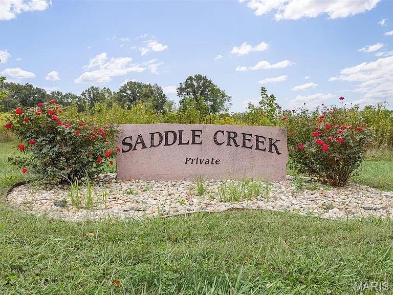 Great residential land lot offering surveyed 5.47 Acres of wooded & approximately 1 acre has been cleared to build your dream home. Saddle Creek Subdivision offers you street lighting & paved roads.